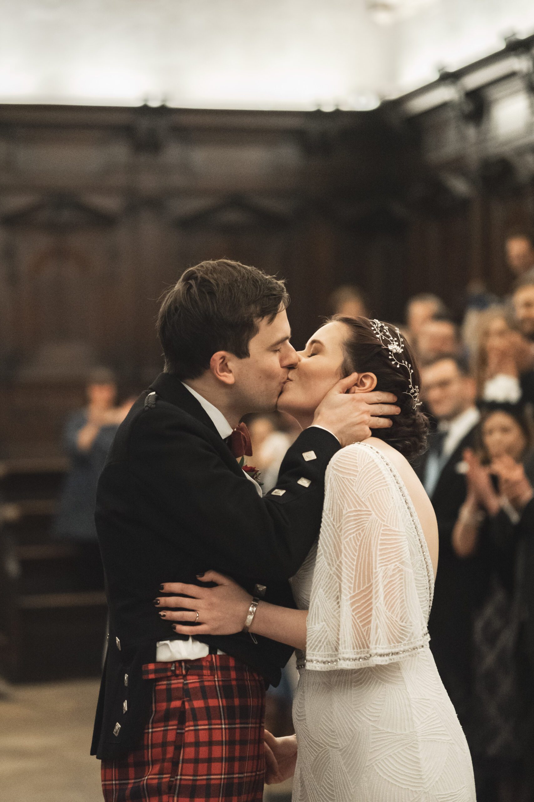 Bride and groom kiss at Bodleian Library, Oxford