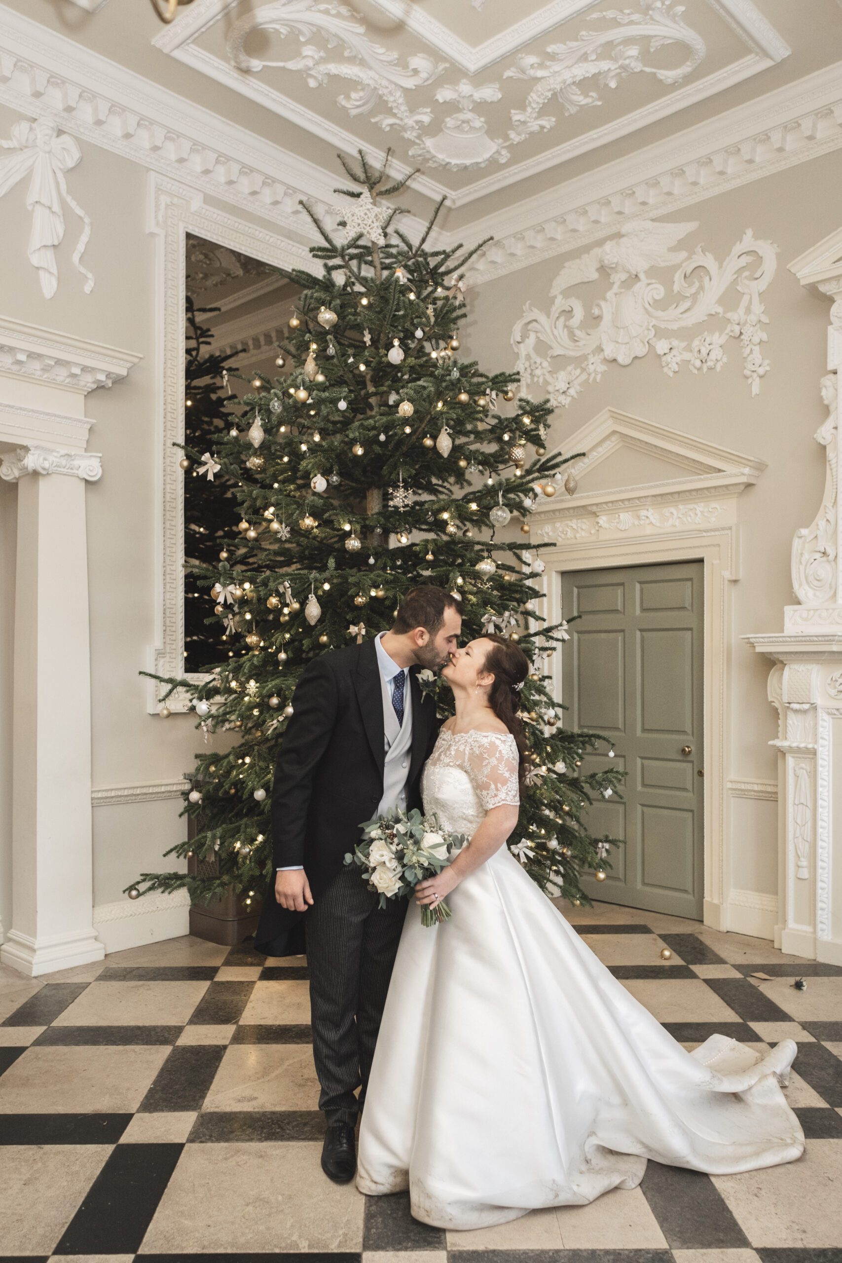 Couple portrait in front of the Christmas tree at Crowcombe court