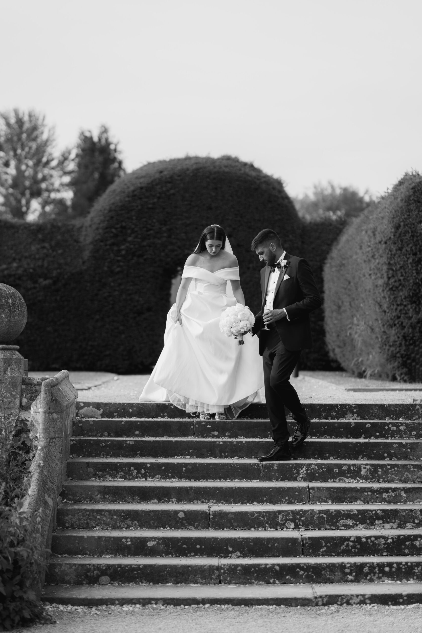 Bride and groom walk down the steps for their editorial wedding photographs at Tortworth Court, Cotswolds
