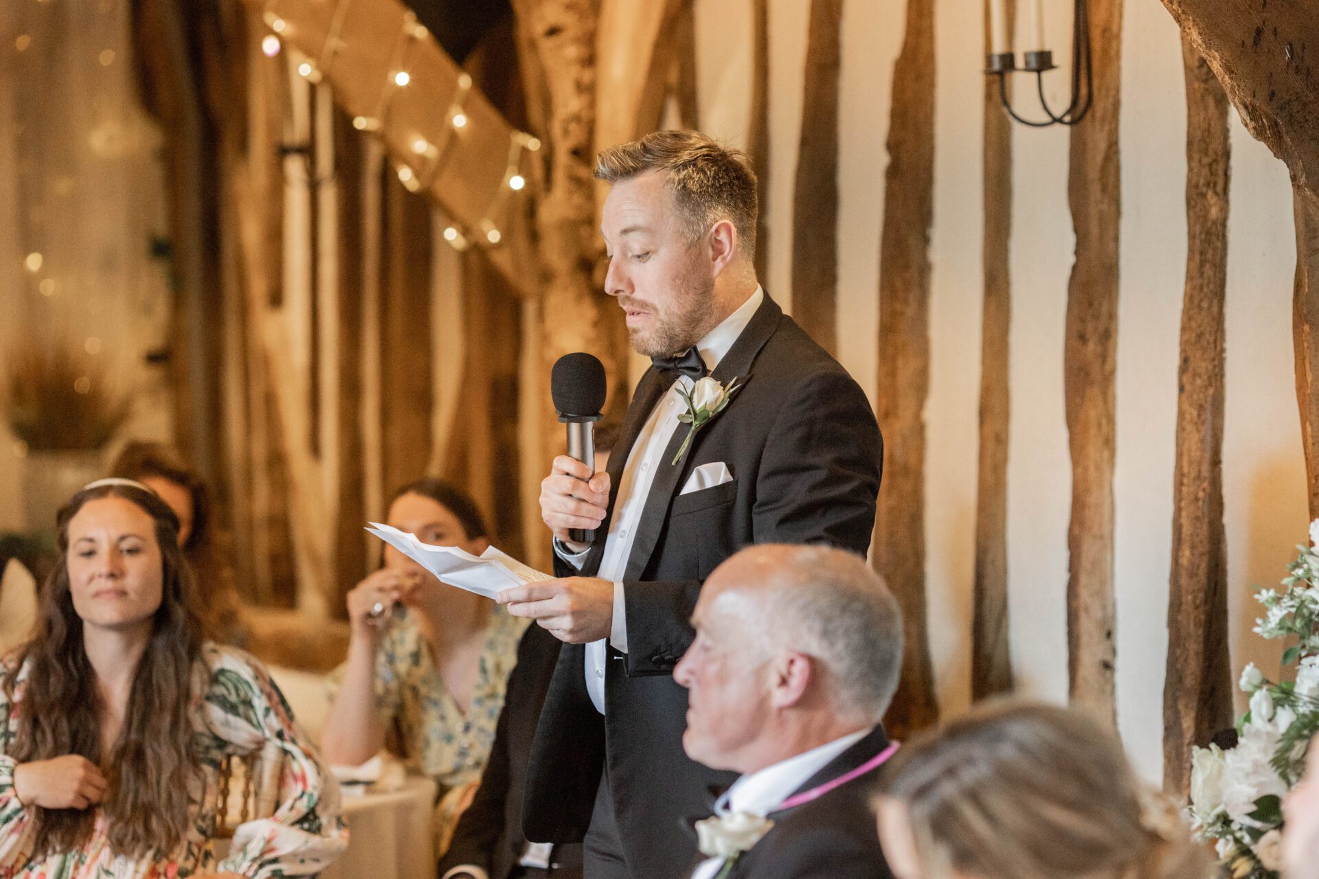The best man gives a speech at Old Luxters Barn wedding venue in Oxfordshire