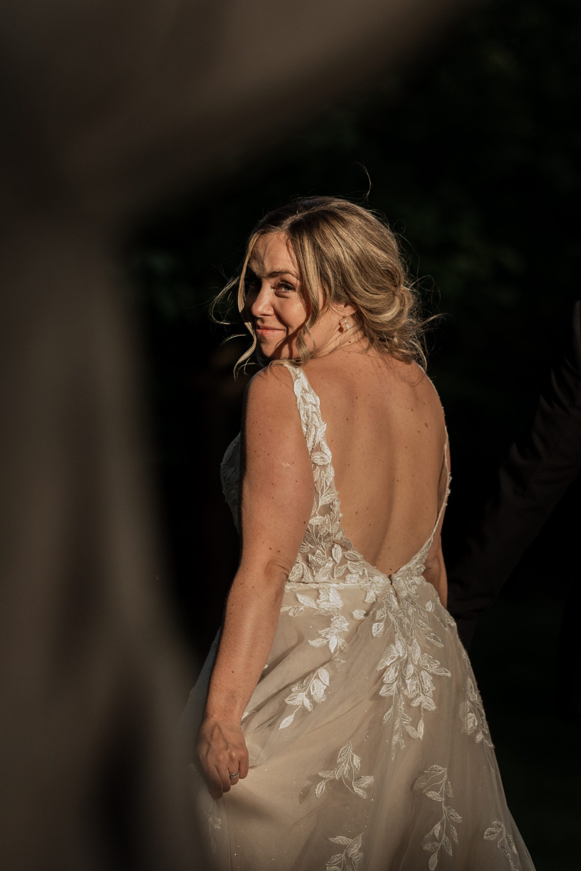 The bride captured in a patch of light during golden hour couple portraits