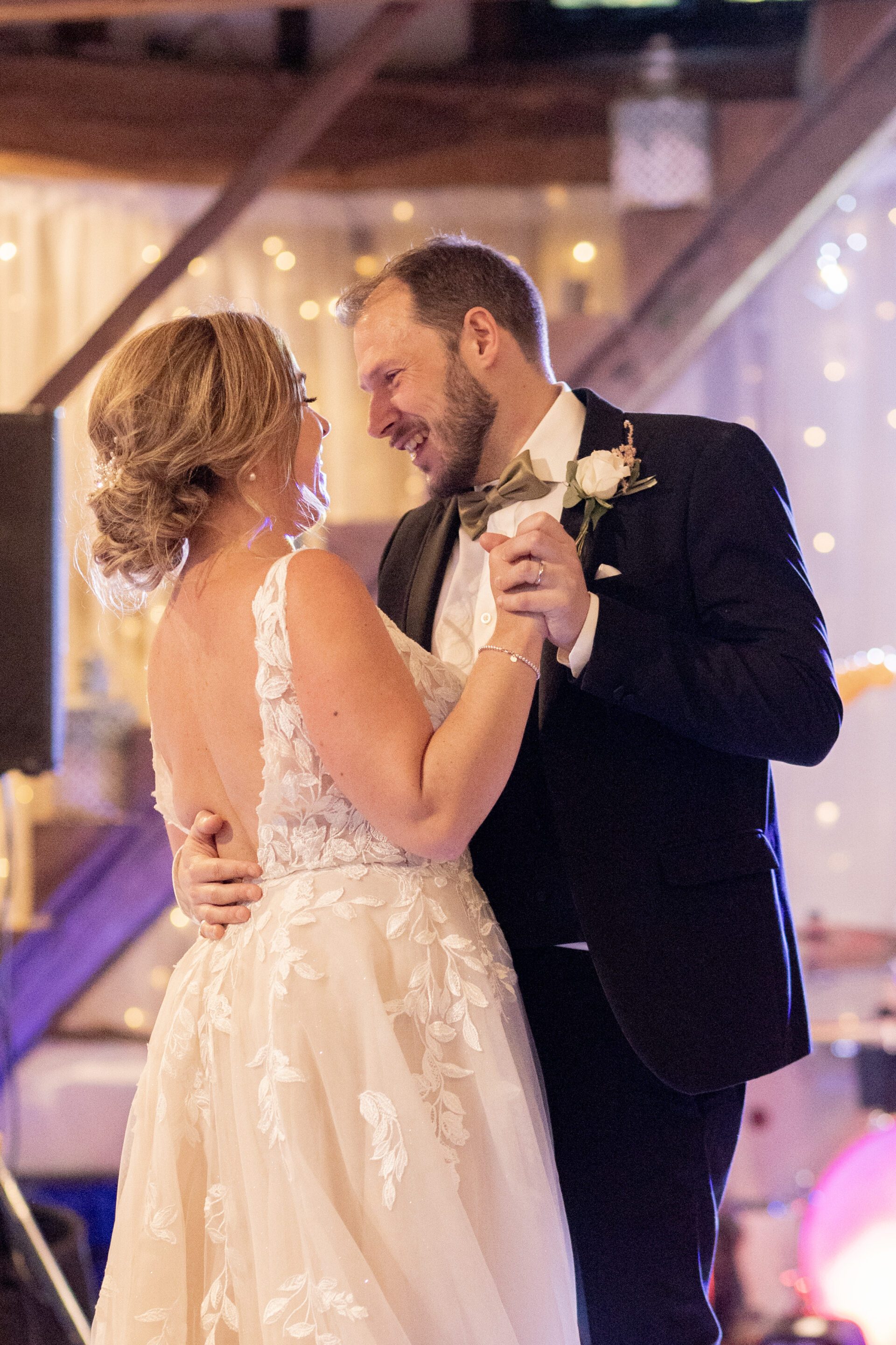 The bride and groom share their first dance at their barn wedding