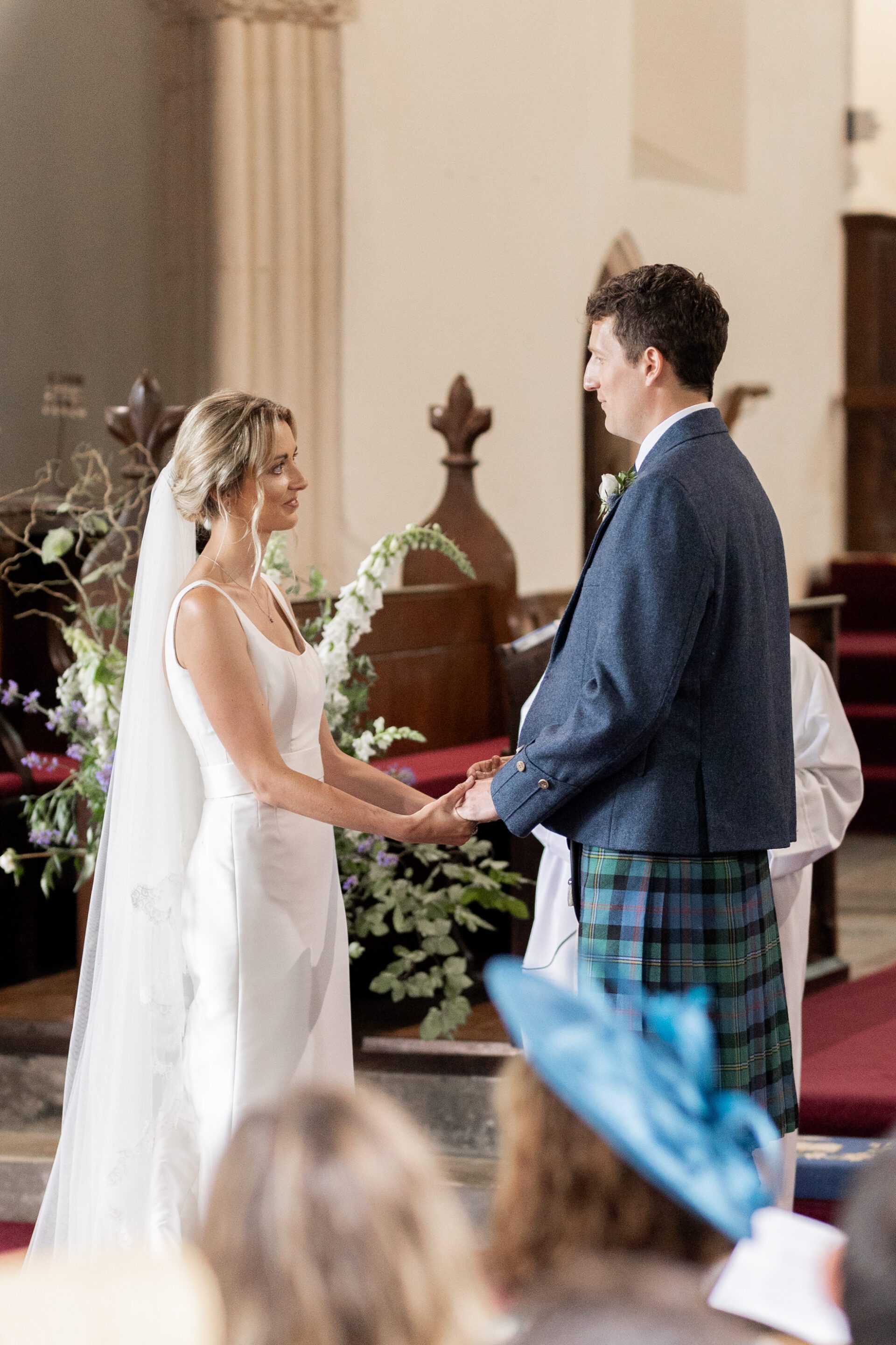 The bride and groom say their vows during their Devon church wedding ceremony