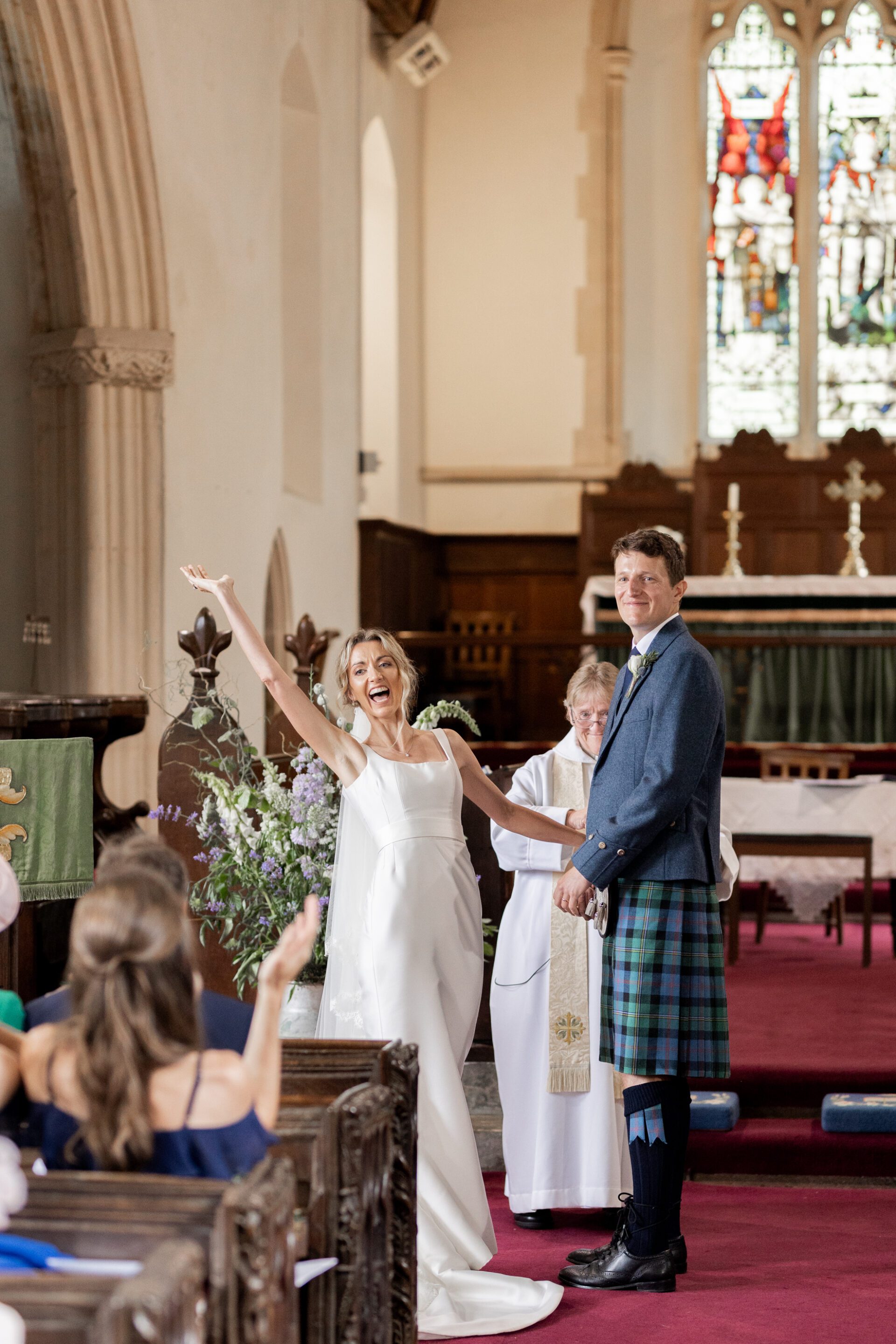 The bride and groom celebrate at their Devon church wedding ceremony