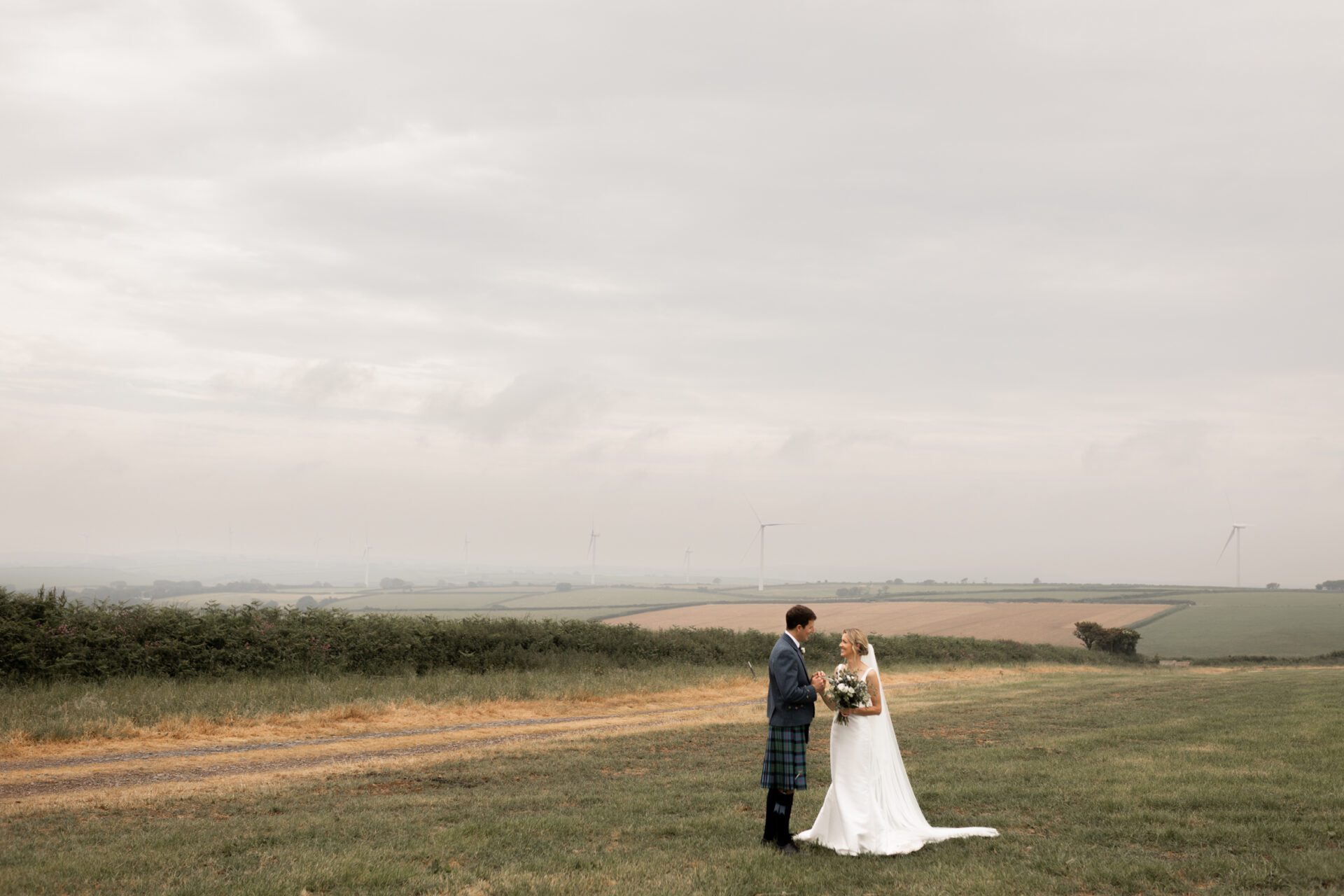 The bride and groom pose for couples photos in the Devon countryside