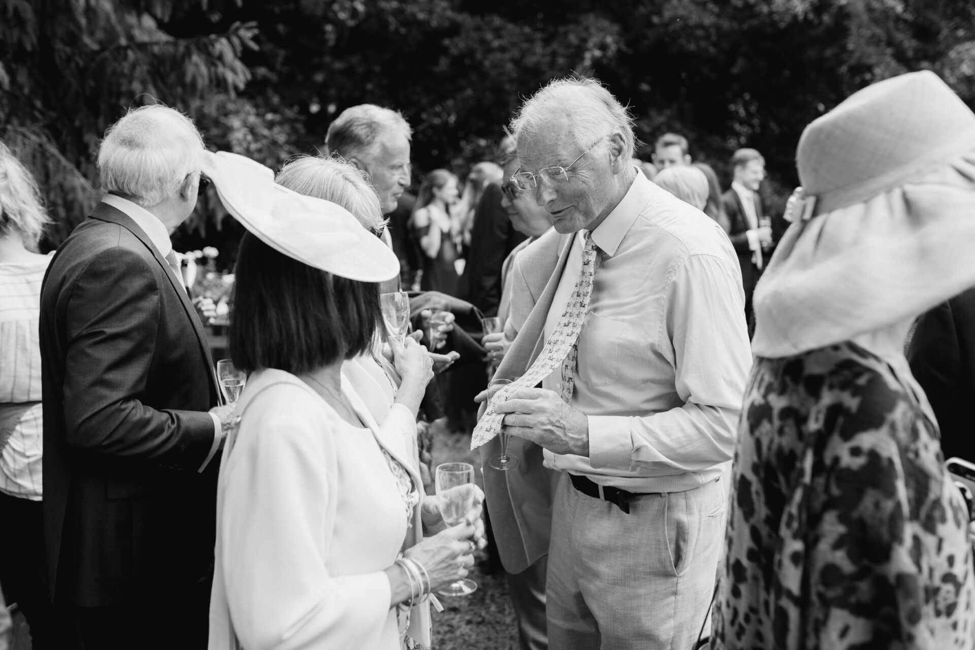 Wedding guests mingle at the outdoor drinks reception