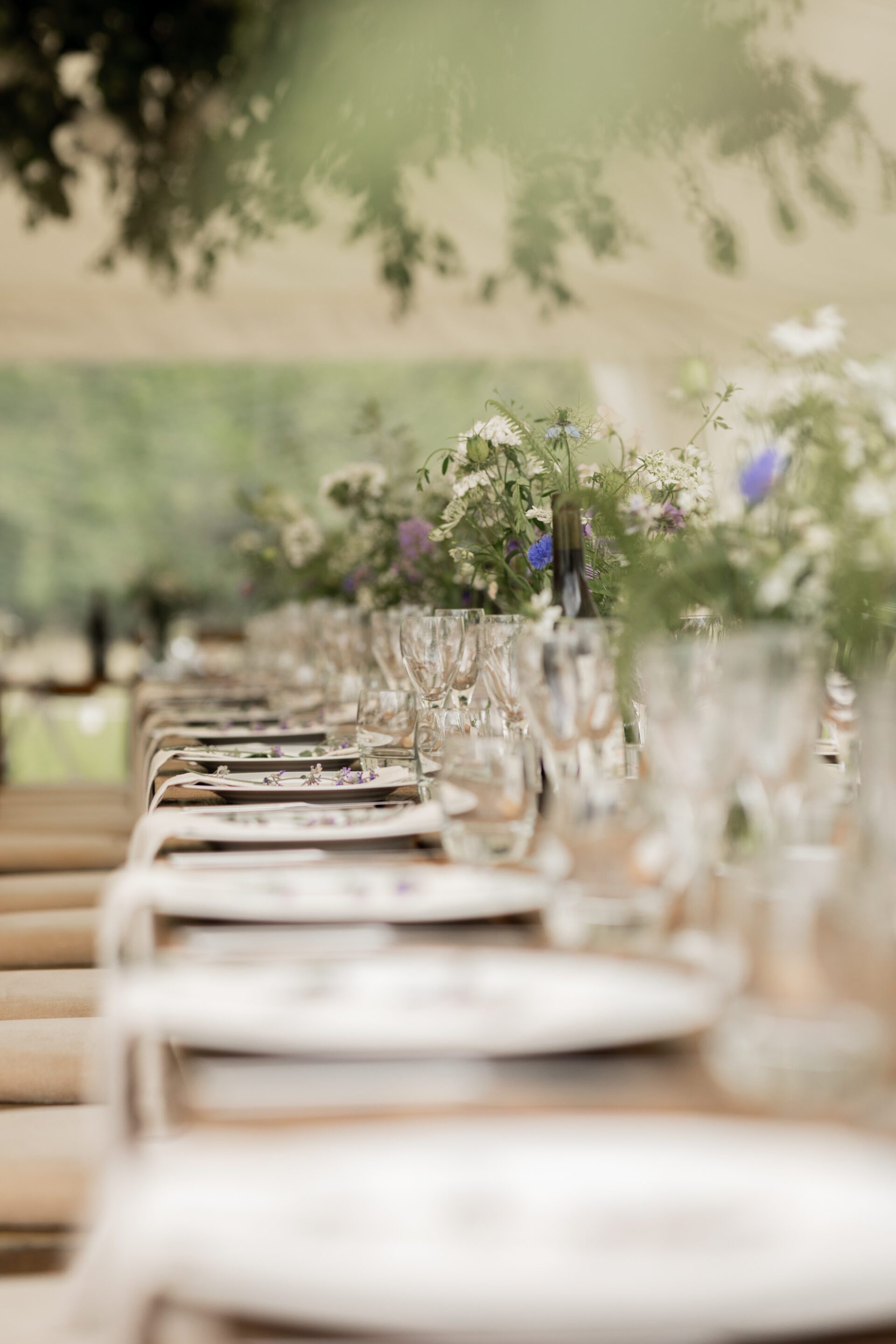 The simple table settings await the guests at this Devon marquee wedding