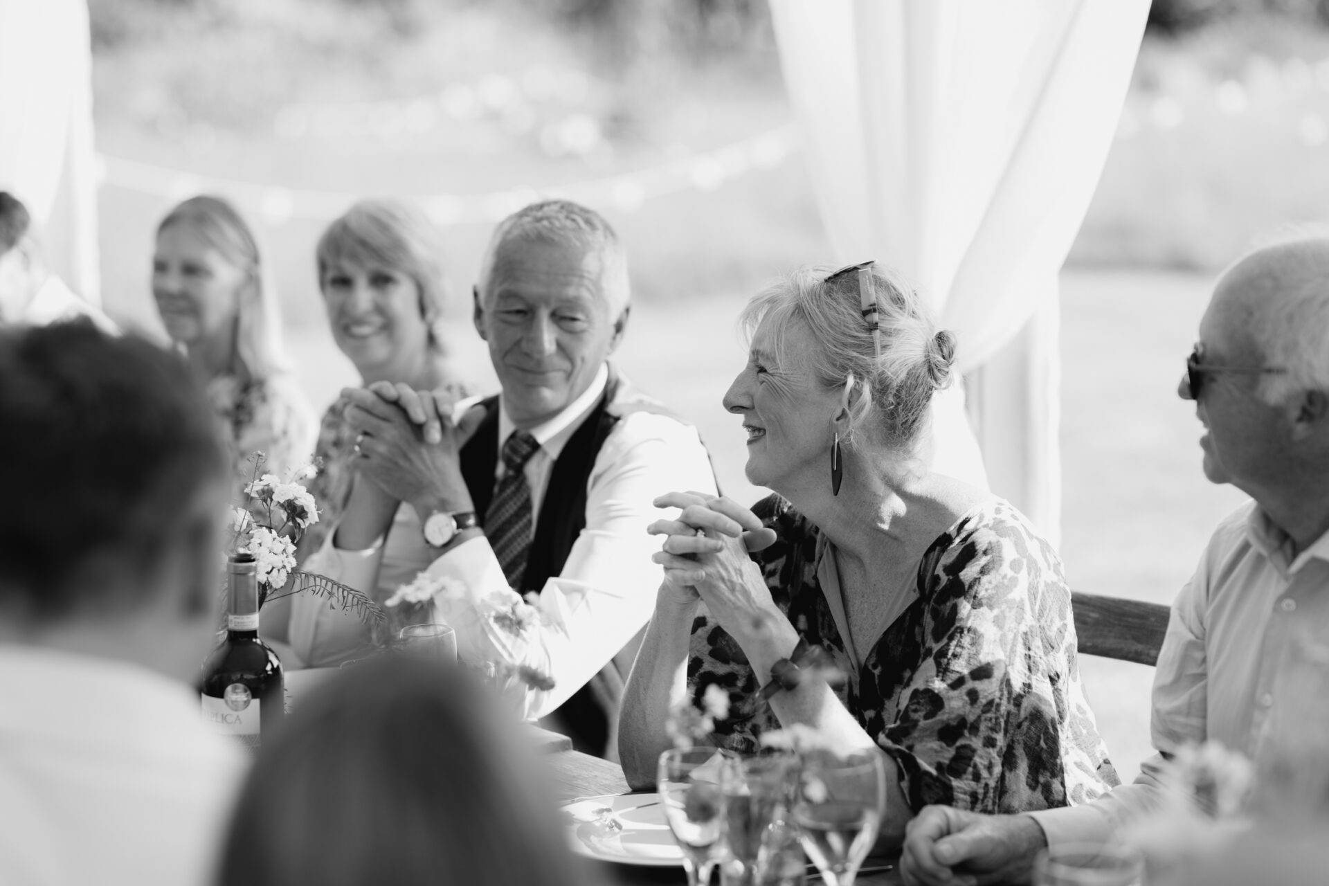 Guests share a smile during the Devon marquee wedding