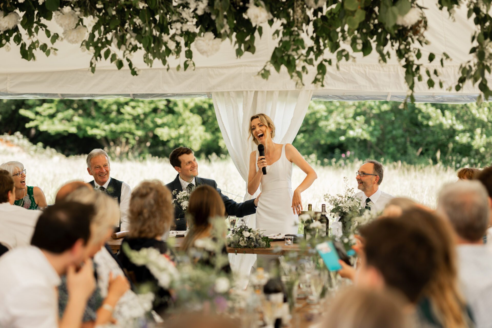 The bride gives a speech at her Devon marquee wedding