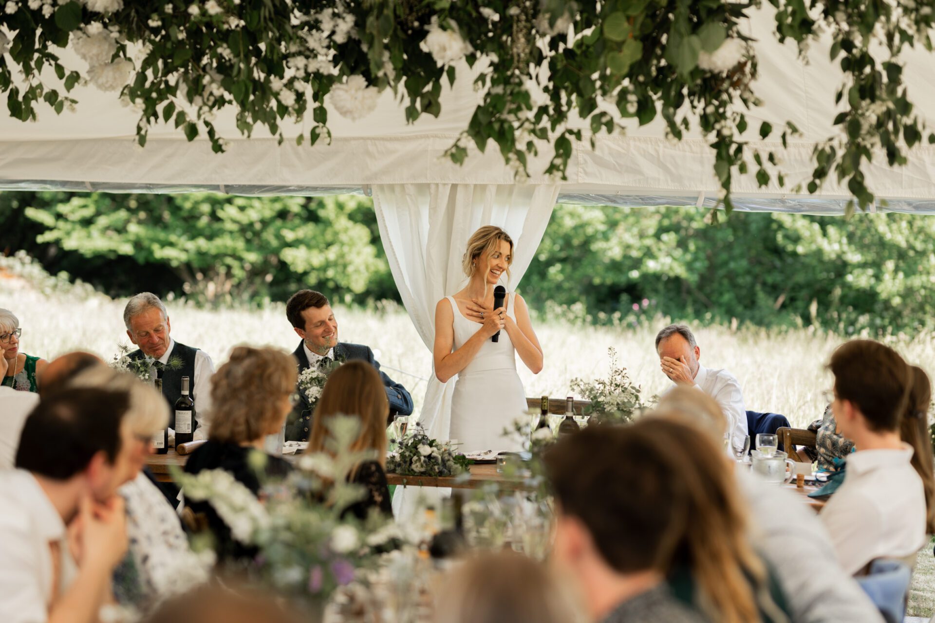 The bride gives a speech at her Devon marquee wedding