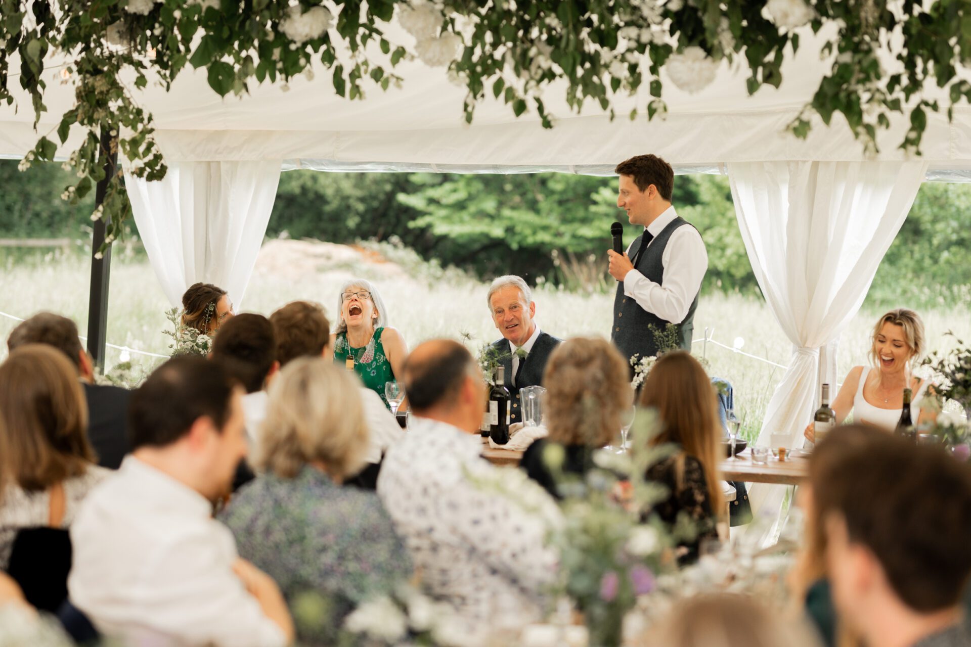The groom gives a speech at his Devon marquee wedding