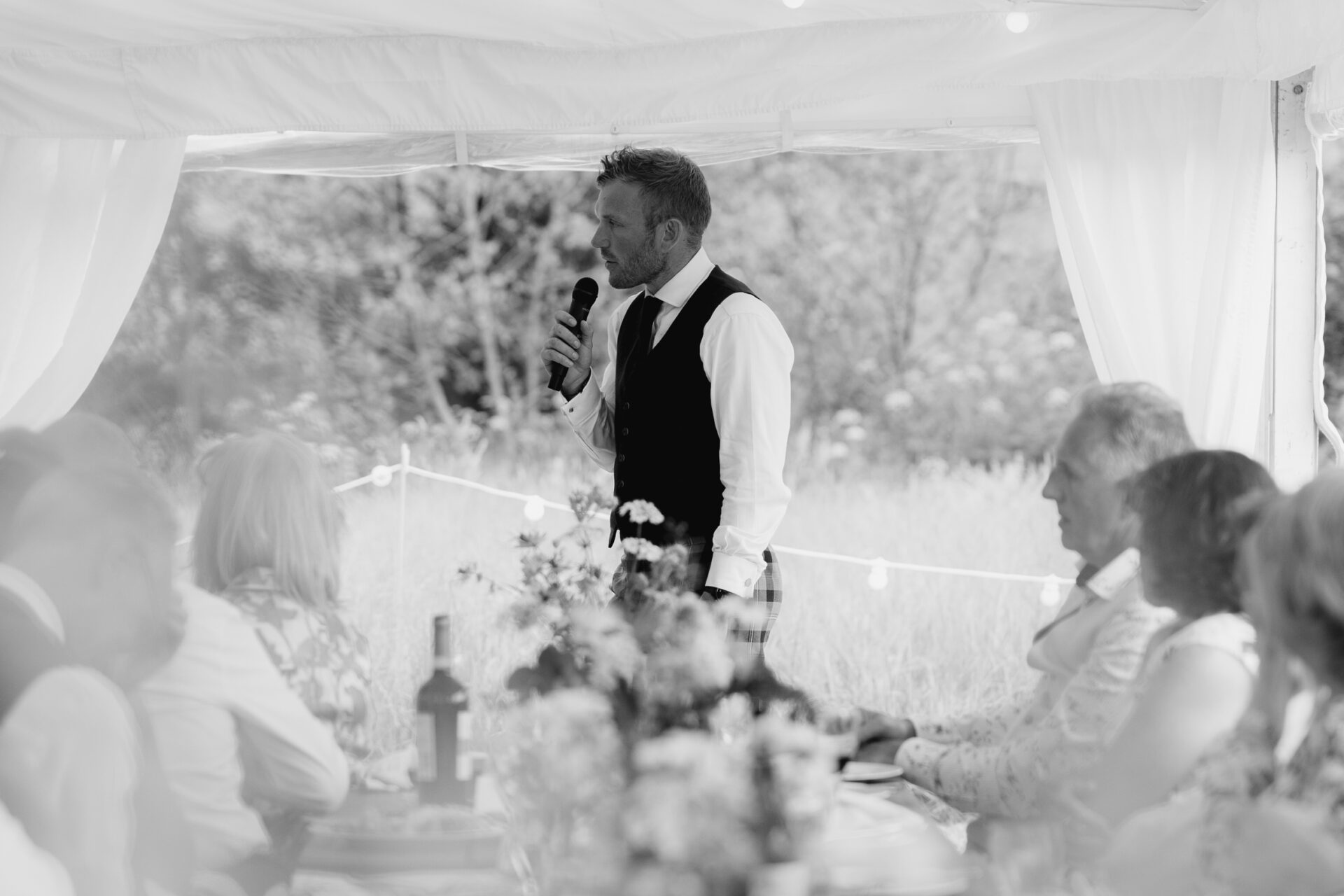 The best man gives a speech at a Devon marquee wedding