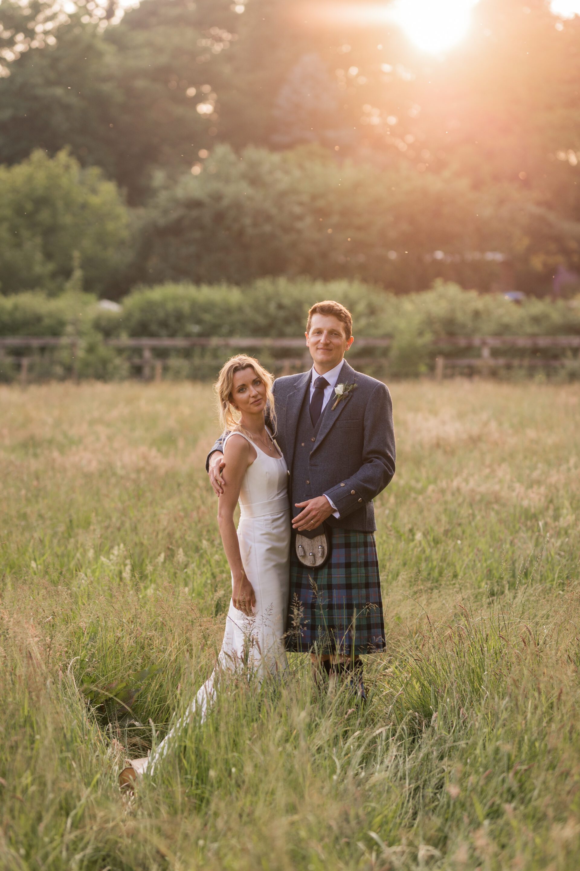 The bride and groom spend five minutes posing for golden hour couples portraits at their Devon marquee wedding