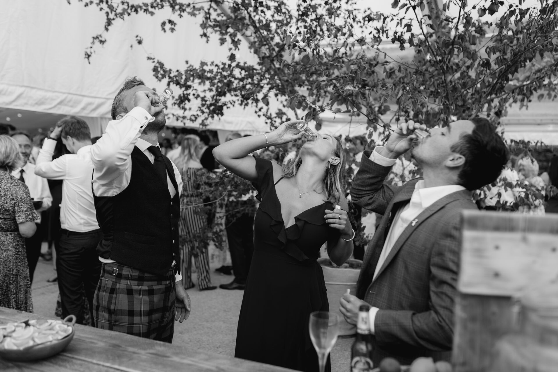 Wedding guests enjoy shots at a Devon marquee wedding
