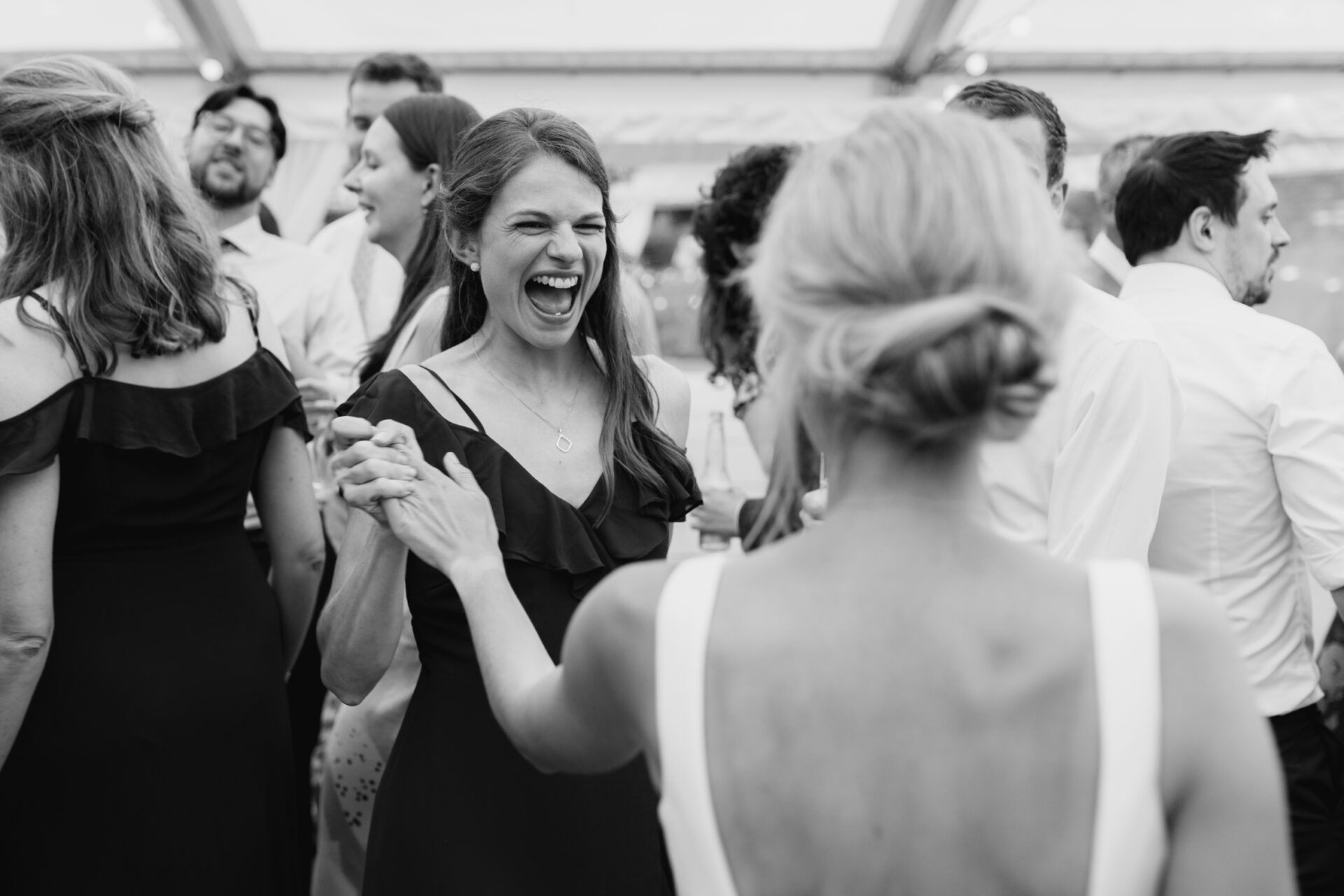 The bride dances with her bridesmaid
