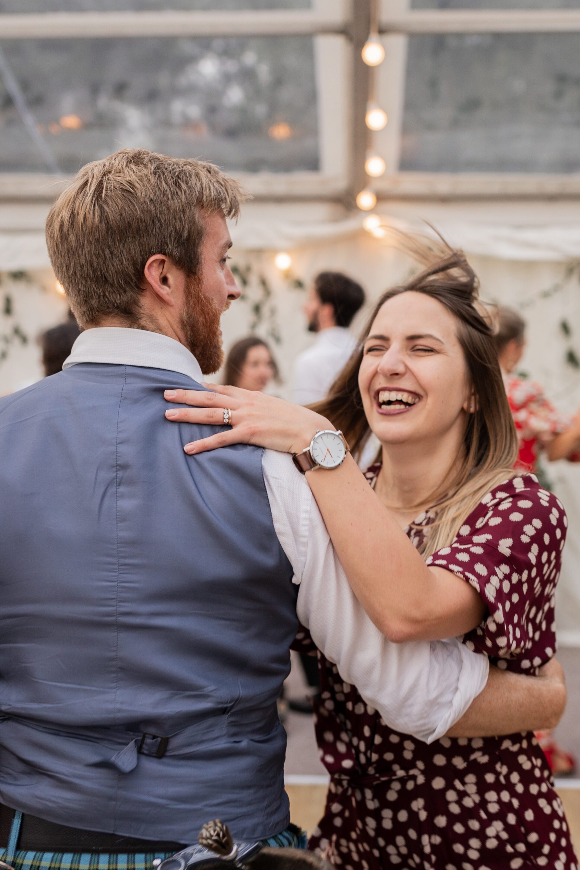 Wedding guests dance together at a marquee wedding