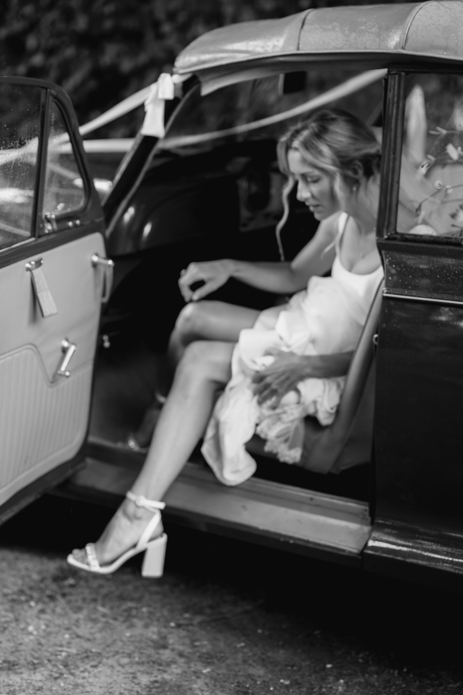 The bride exits the vintage wedding car