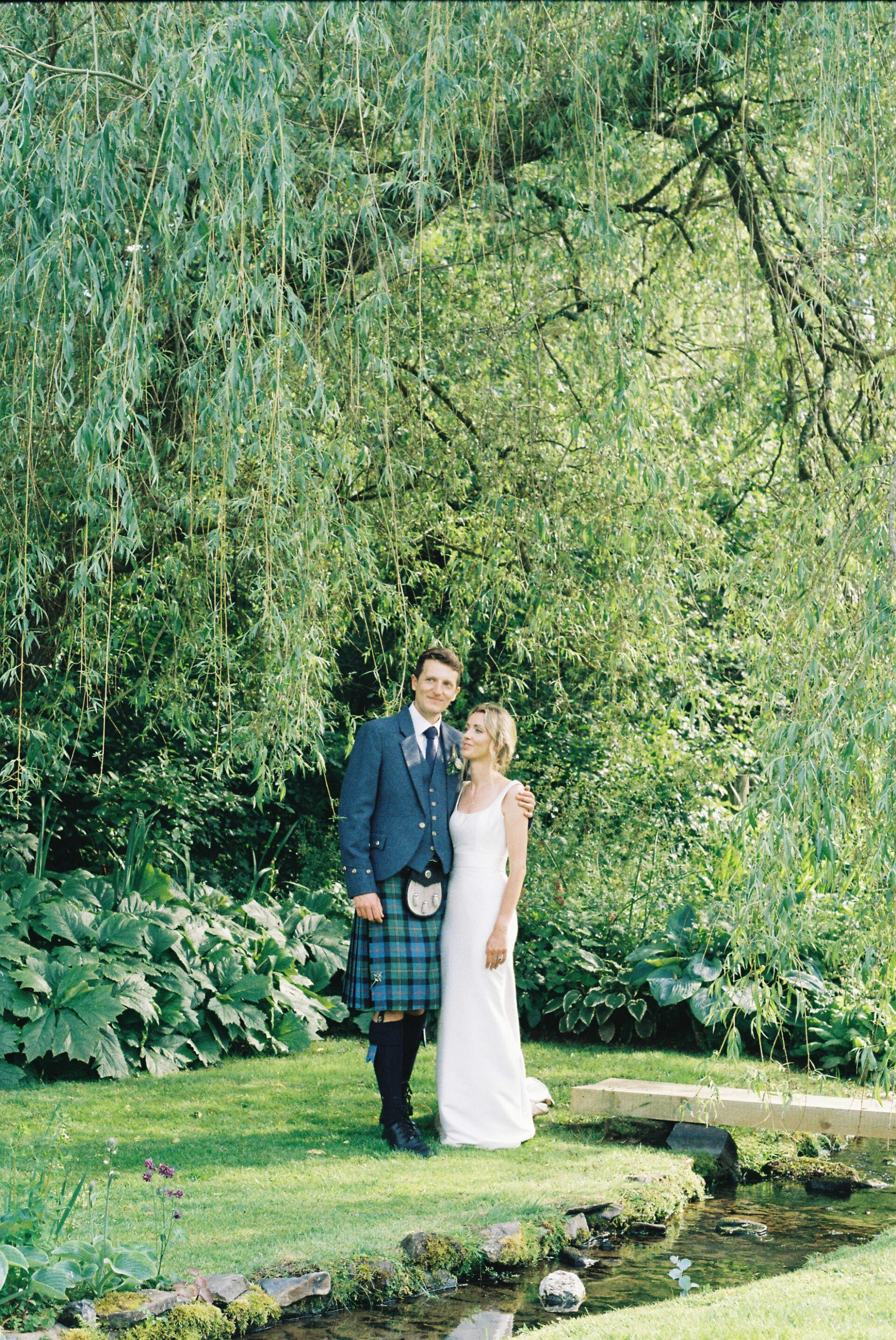The bride and groom are captured on 35mm film during their couples portrait session