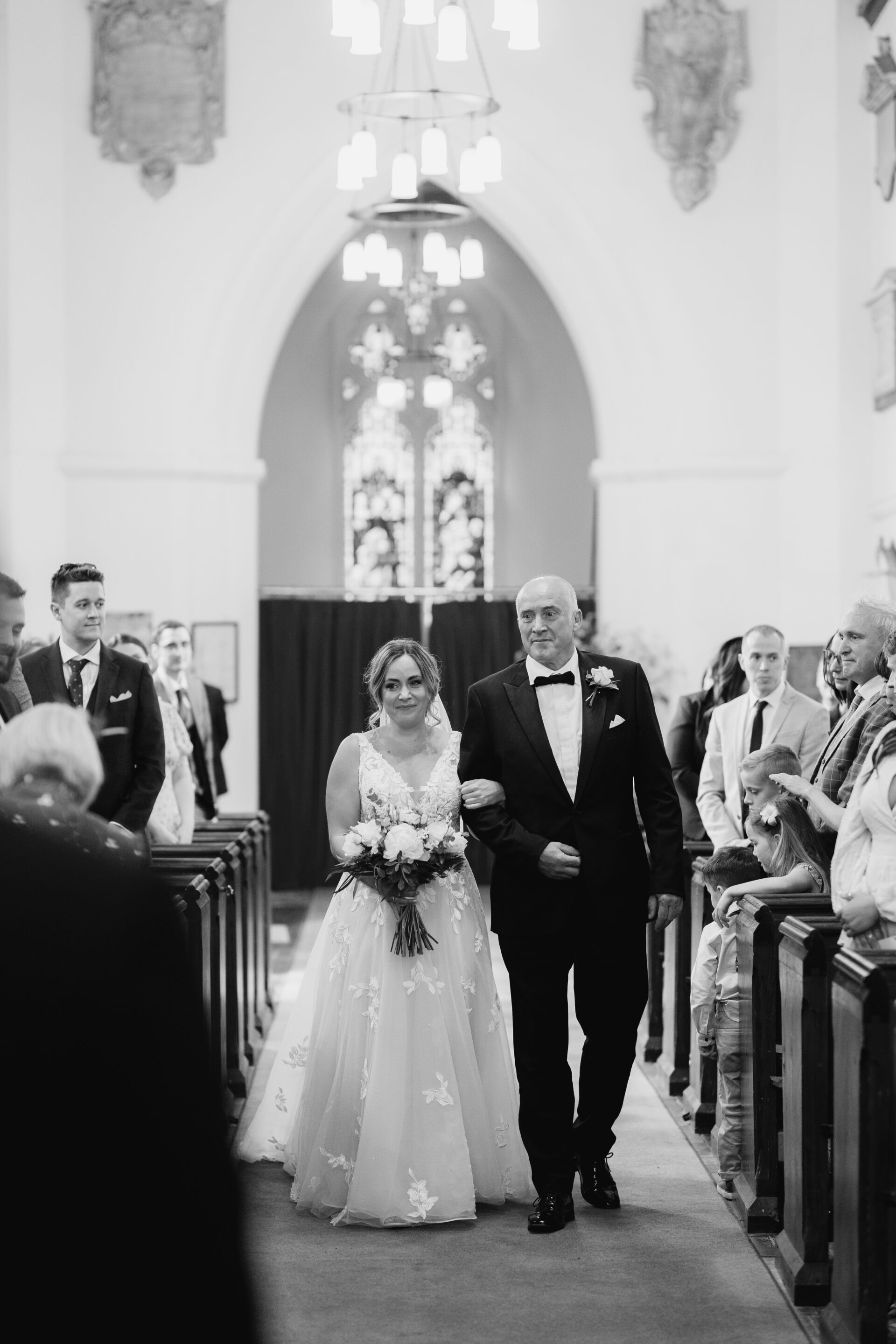The bride and her father walk down the aisle