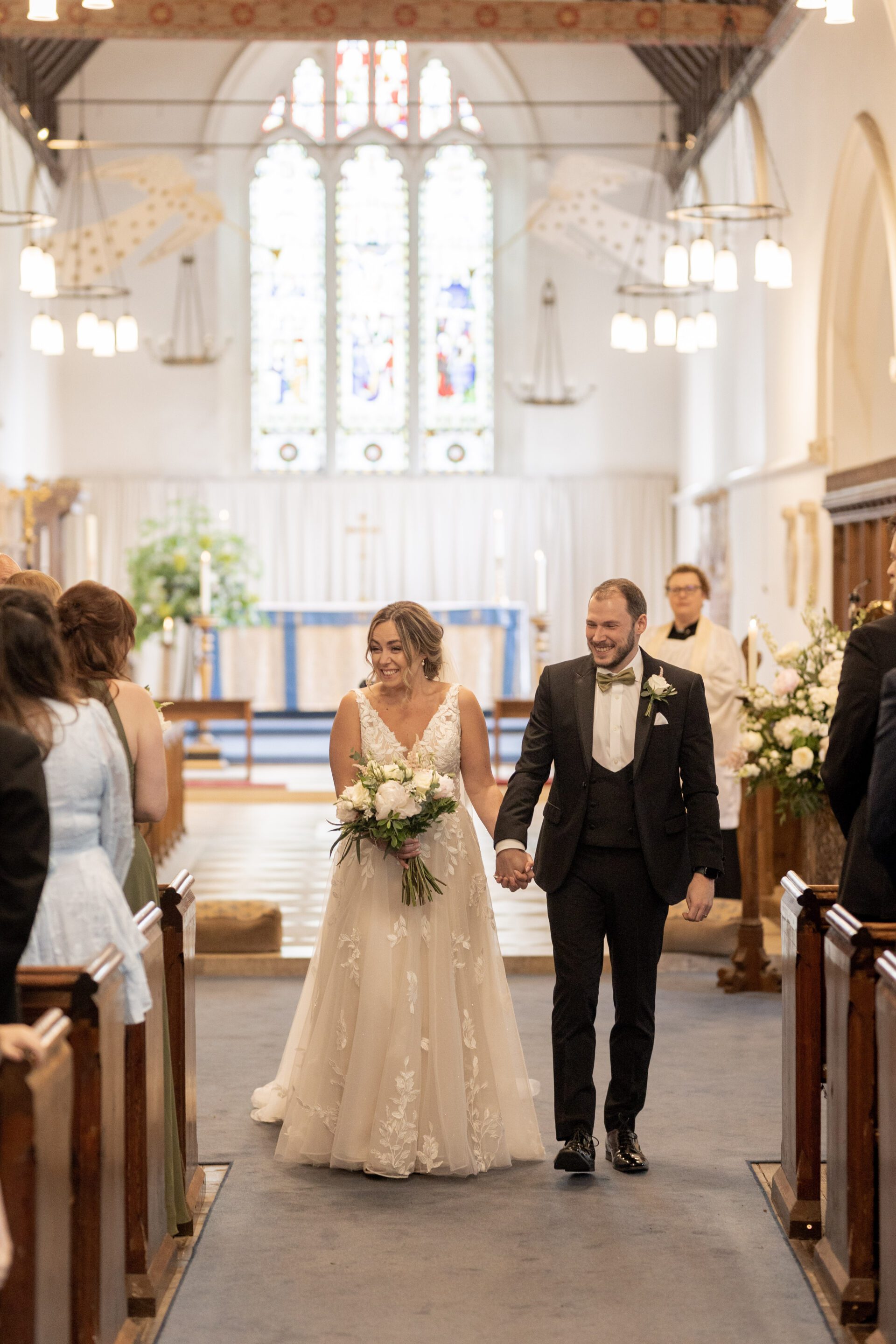 The bride and groom walk back down the aisle after getting married