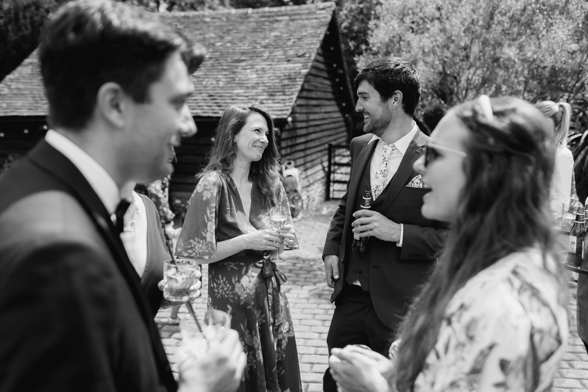 The wedding guests enjoy the drinks reception at Old Luxters Barn