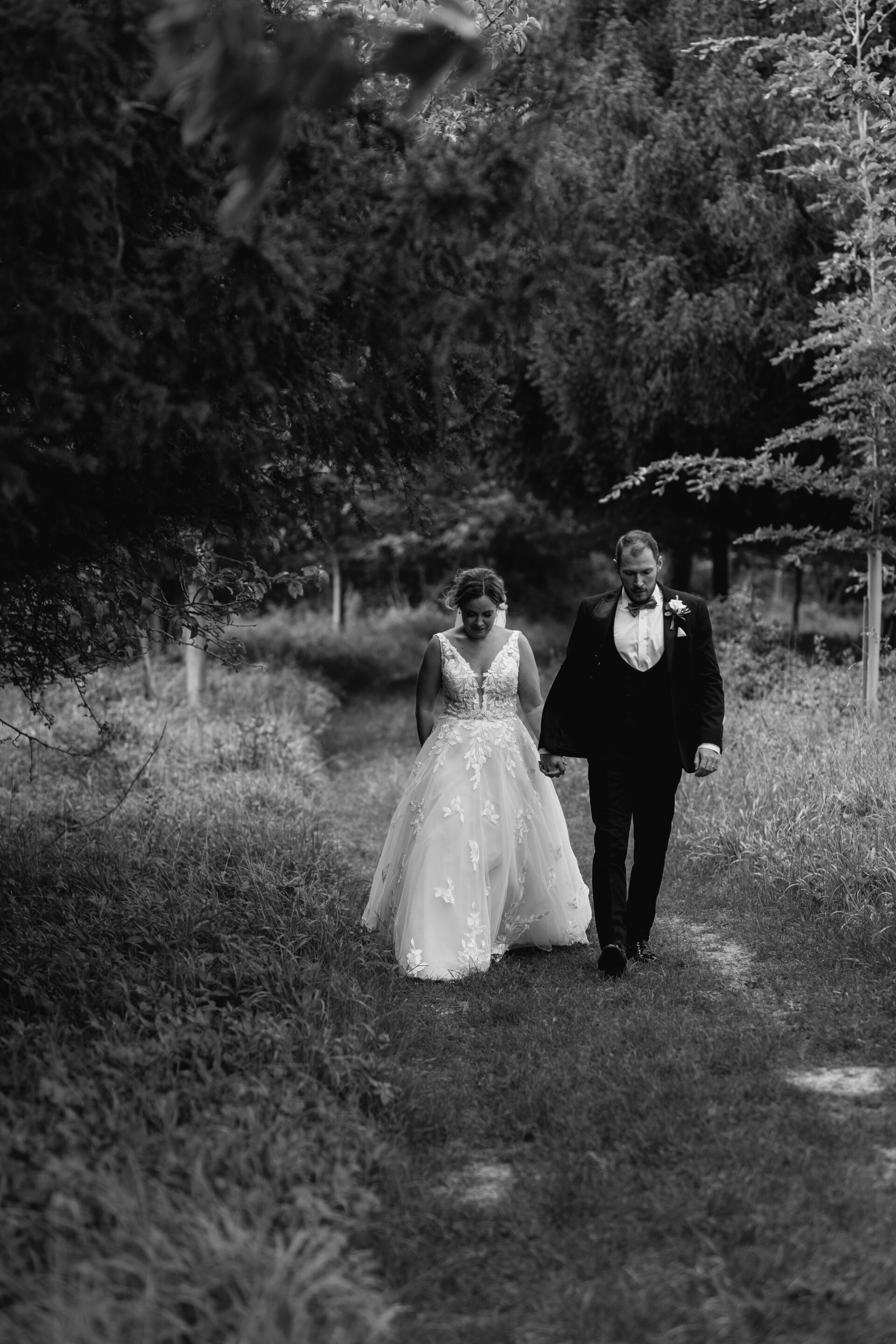 The bride and groom walk hand in hand during our couples portrait session at Old Luxters Barn in Oxfordshire