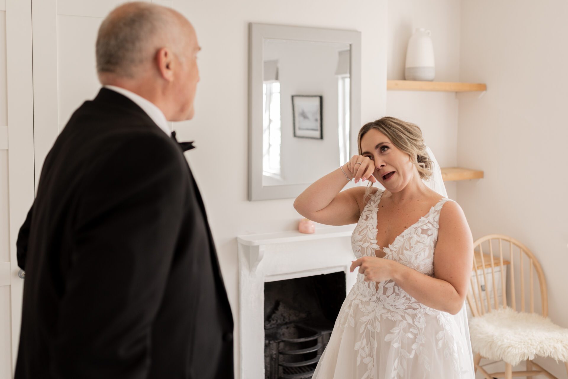 The bride sheds a tear during a first look with her father