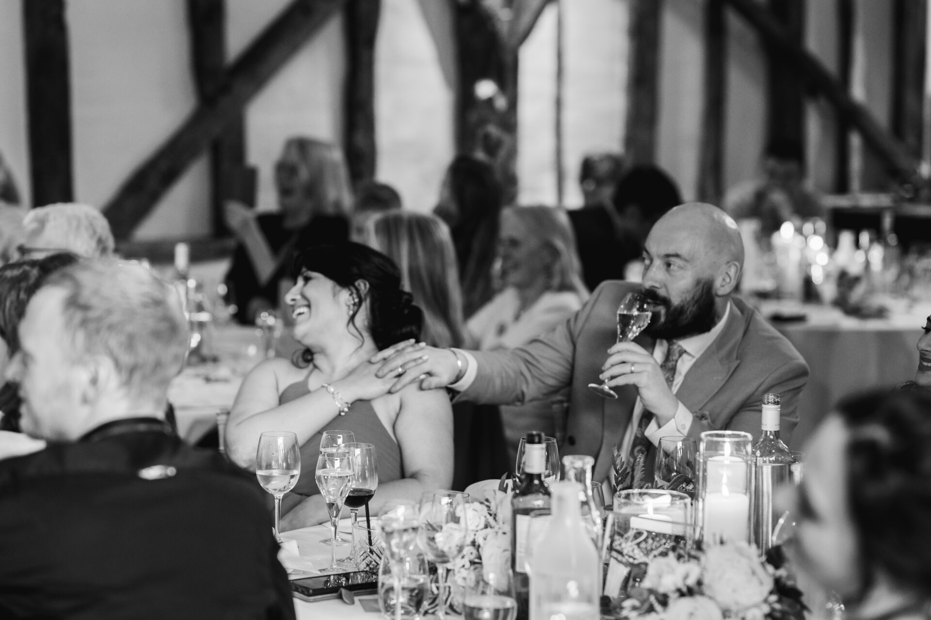 Wedding guests listen to speeches at Old Luxters Barn wedding venue in Oxfordshire