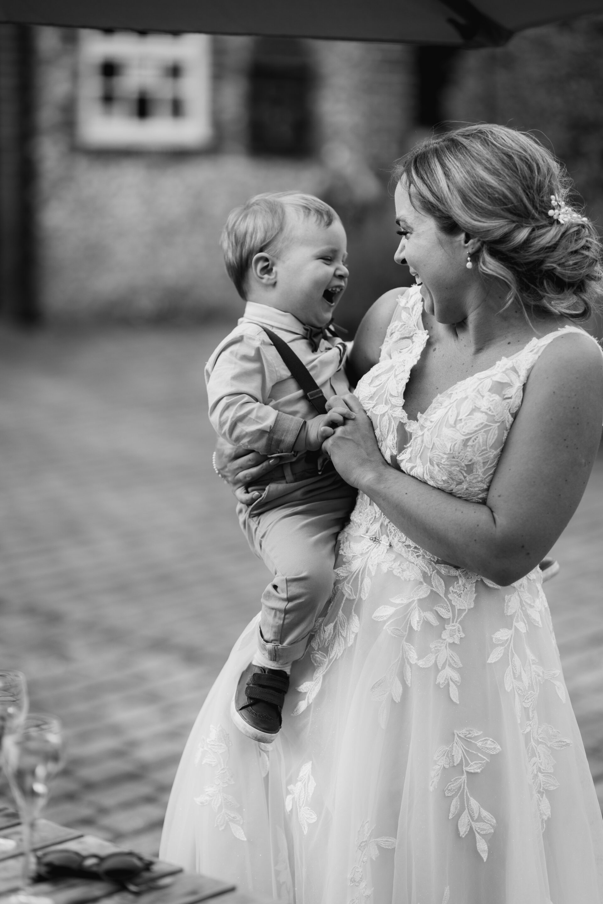 The bride embraces her son at Old Luxters Barn wedding venue in Oxfordshire