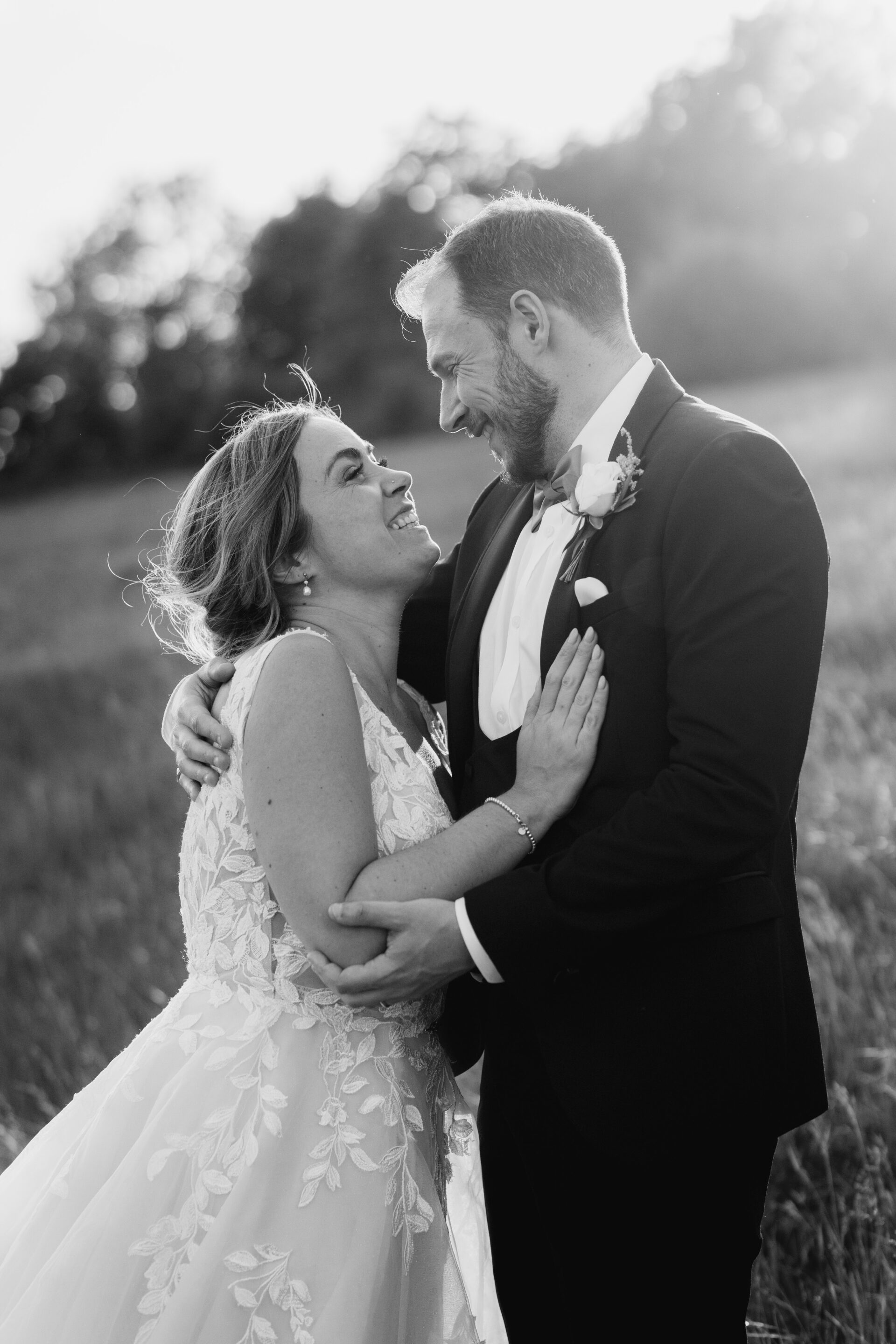 The bride and groom share a laugh during their couples portrait session