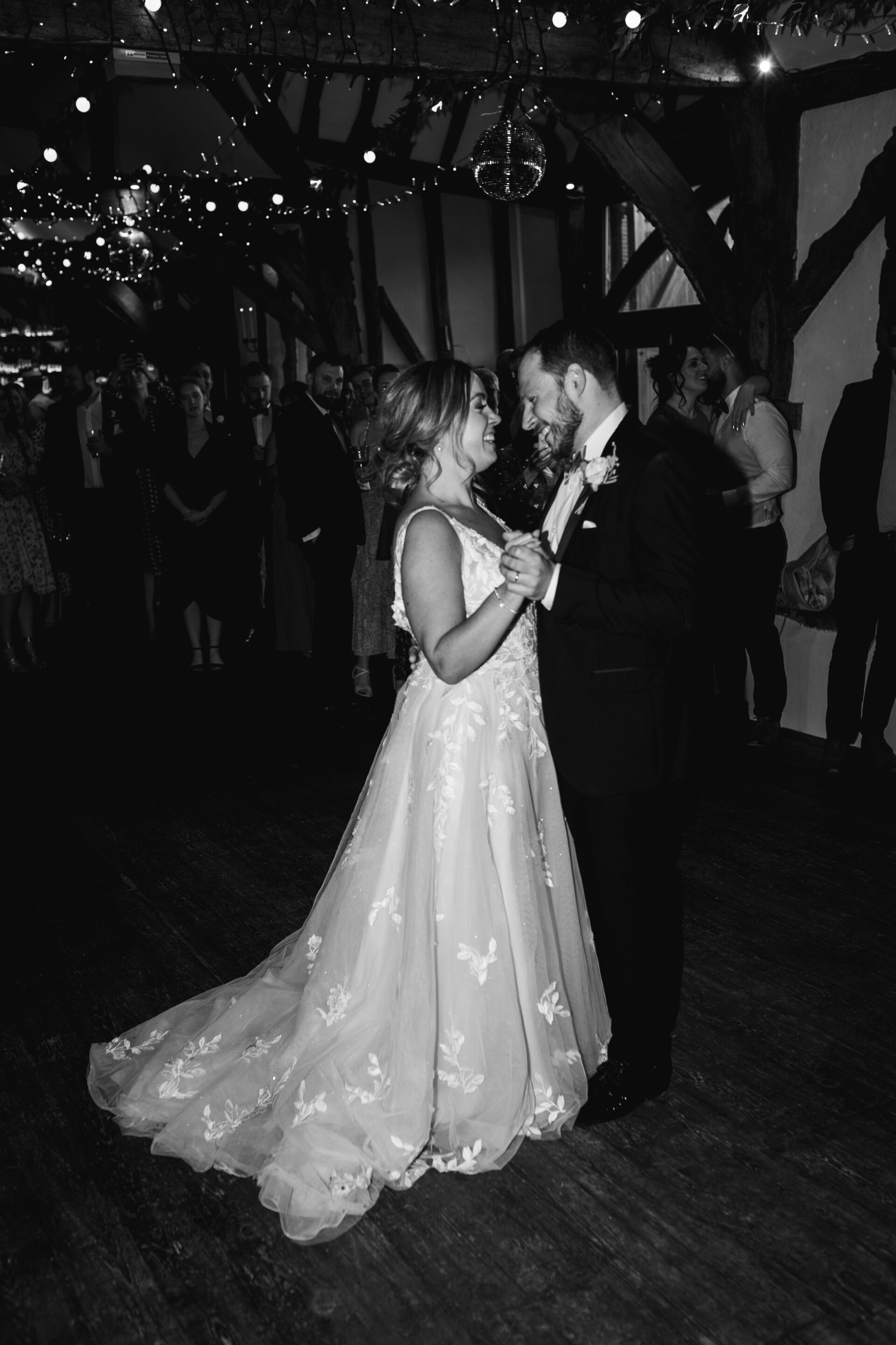 The bride and groom share their first dance at Old Luxters Barn wedding venue in Oxfordshire