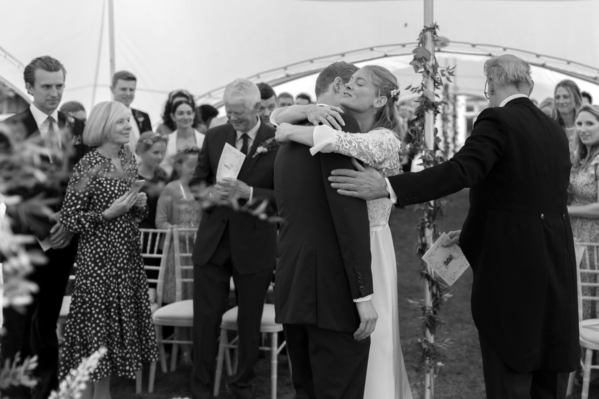 The bride embraces the groom at their Kent wedding
