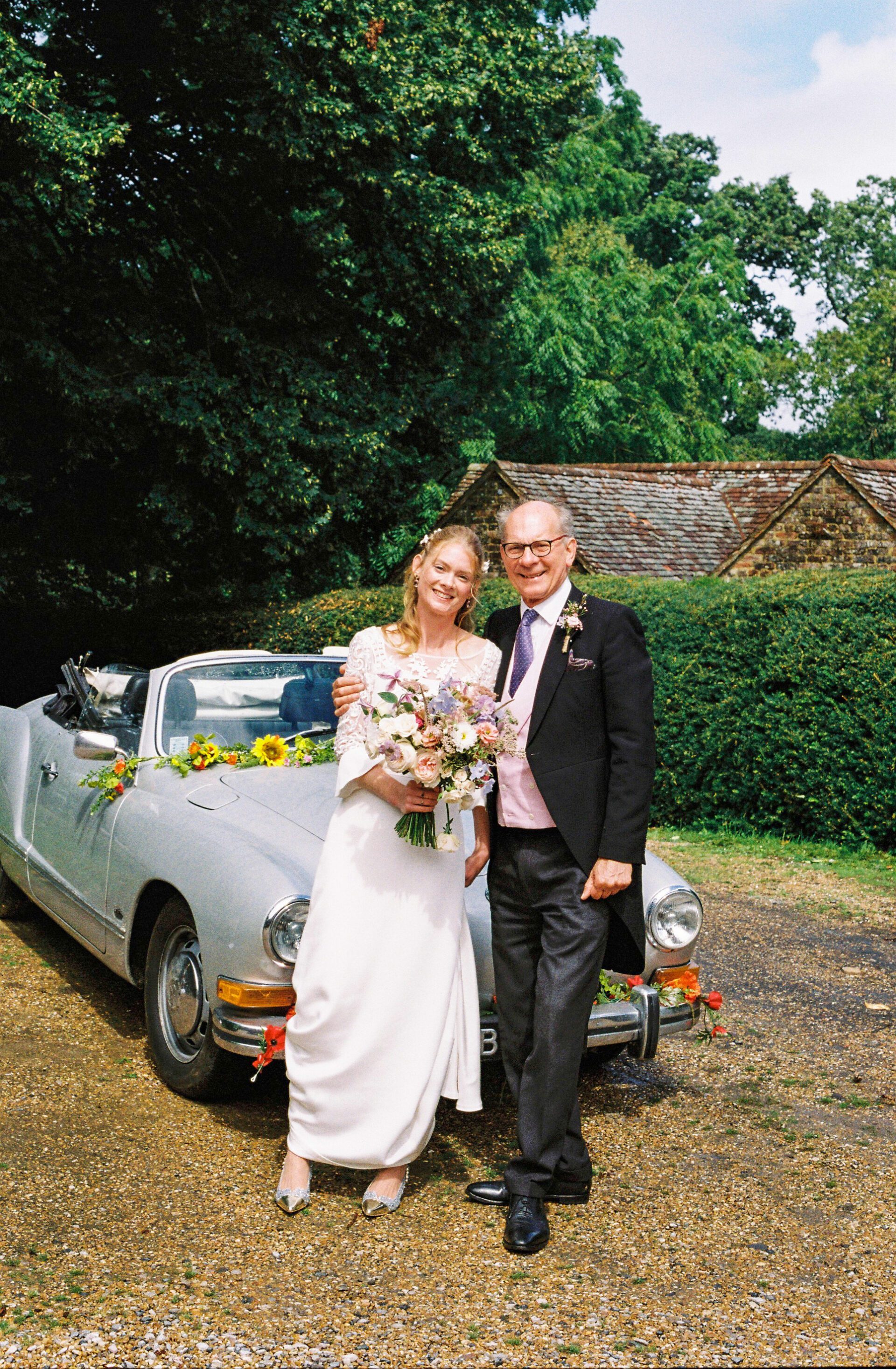 35mm portrait of the bride and her father before driving to Brickwall House, Kent wedding venue