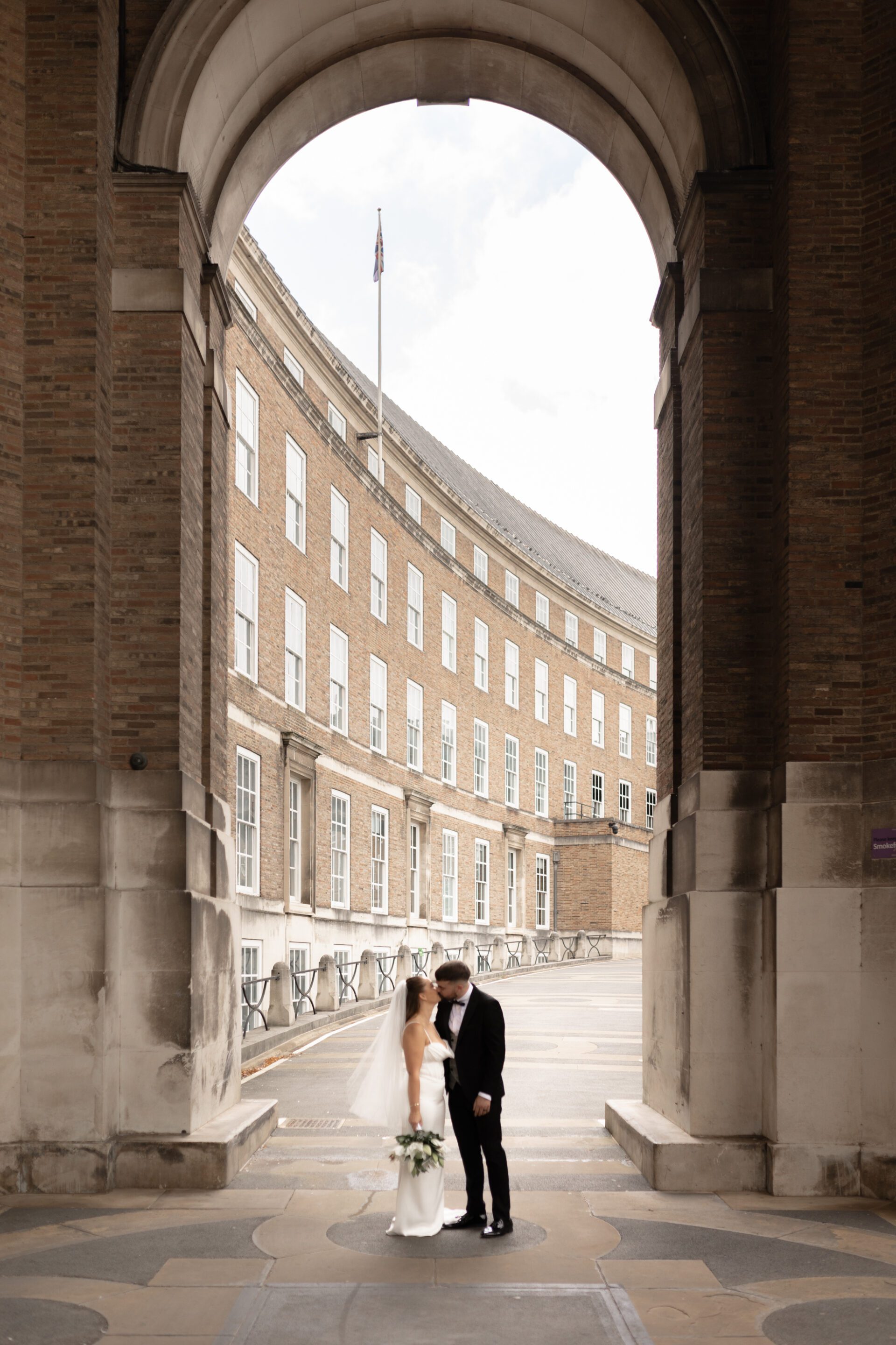 The bride and groom pose amidst Bristol's iconic architecture during our couple portrait session
