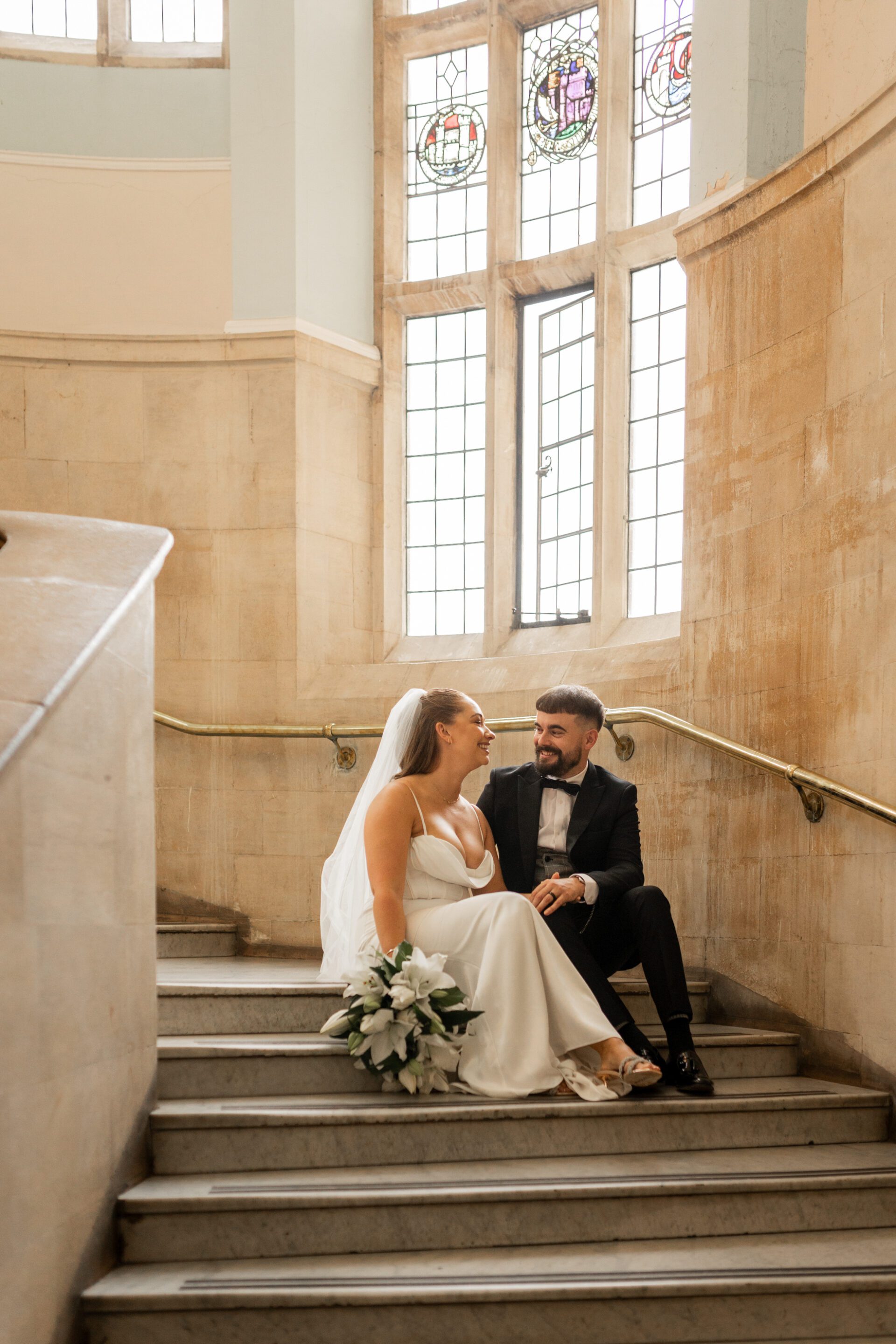 The bride and groom pose for editorial couple portraits at Bristol Library