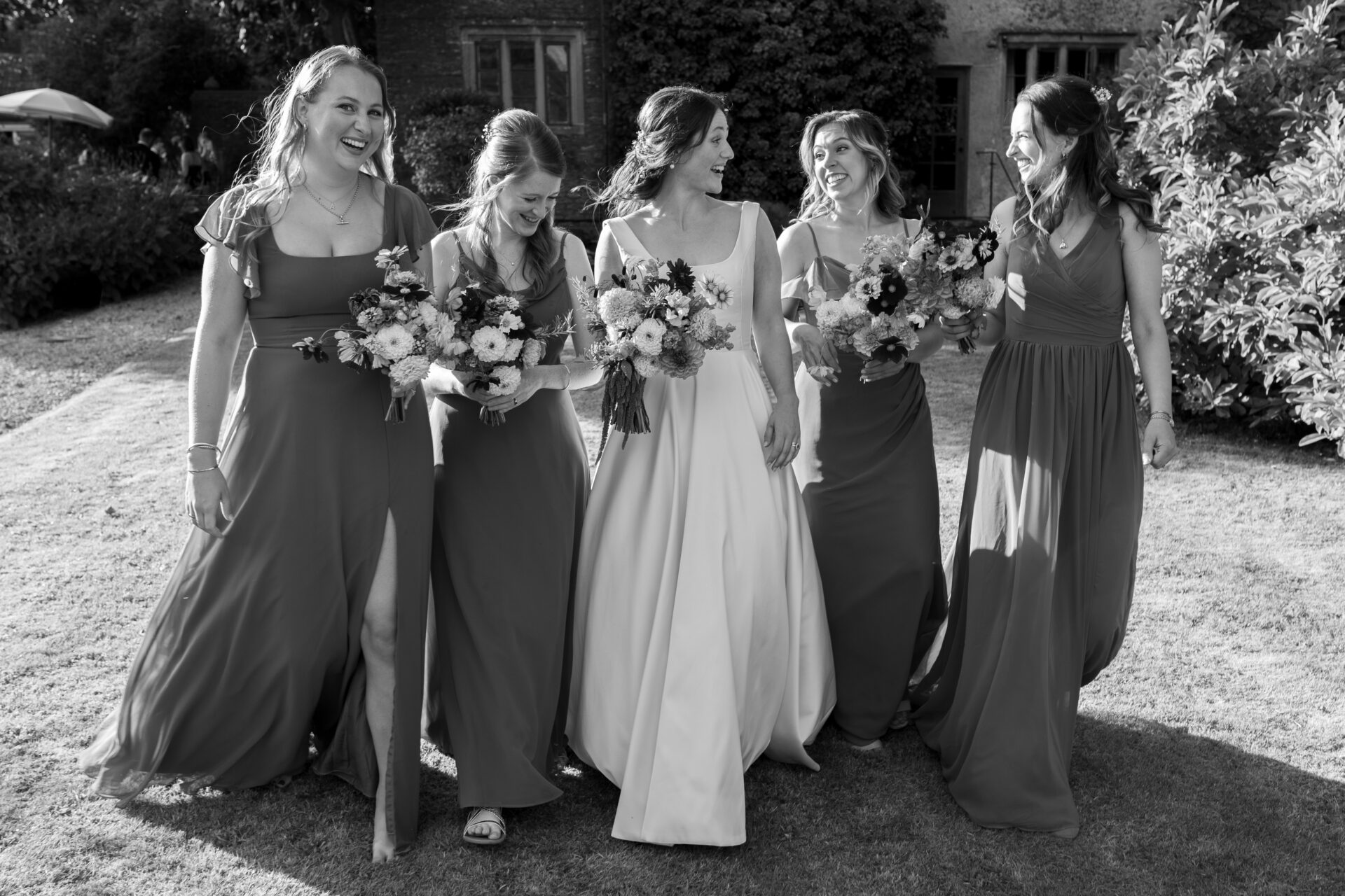 The bride poses for photos with her bridesmaids during her Somerset marquee wedding reception