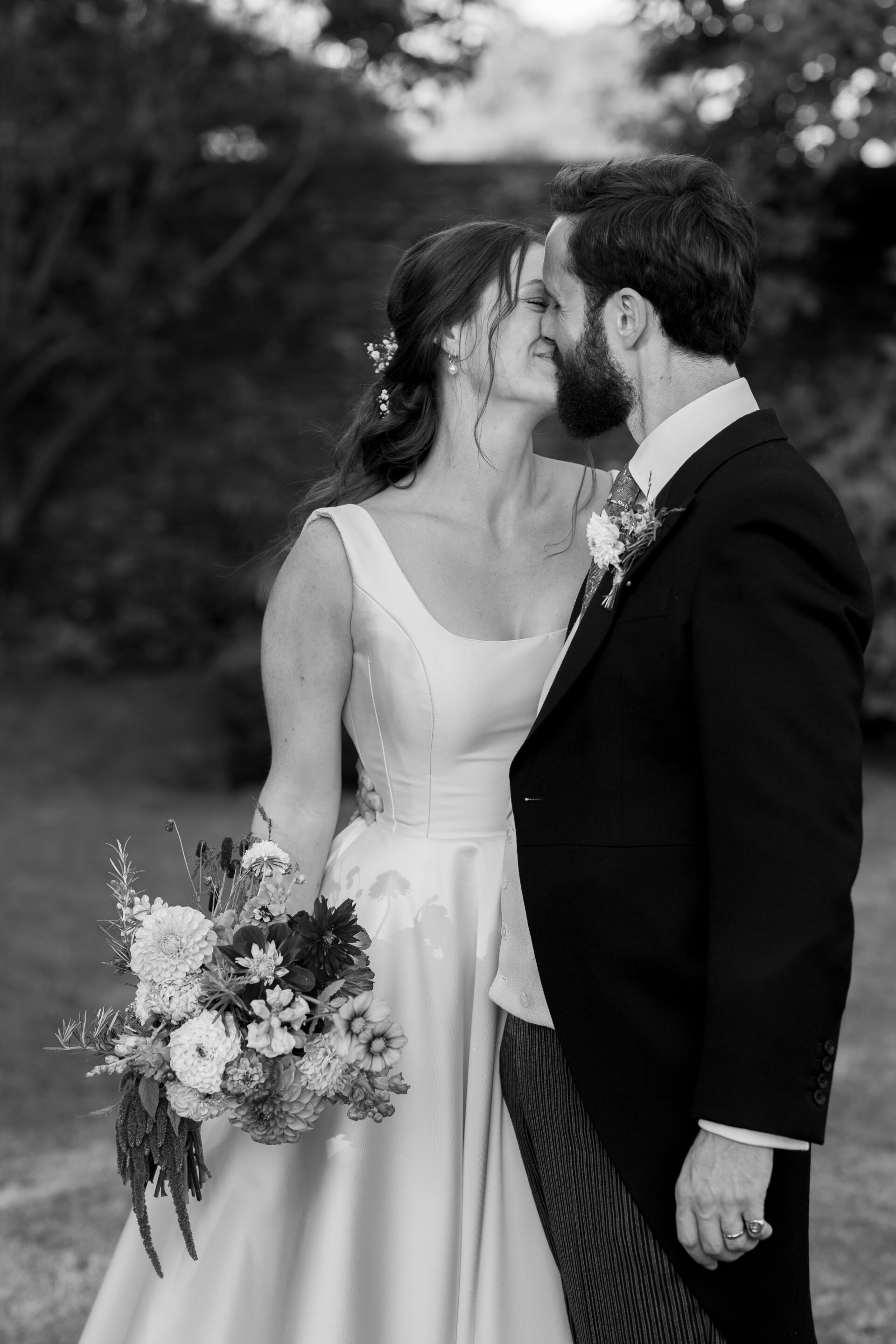 The bride and groom share a kiss during their Somerset marquee wedding reception