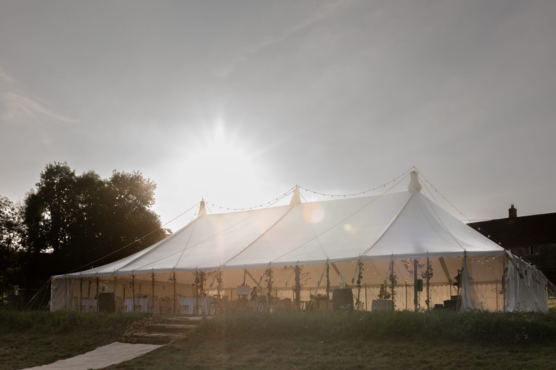 Golden hour at the The bride and groom share an embrace during their Somerset marquee wedding