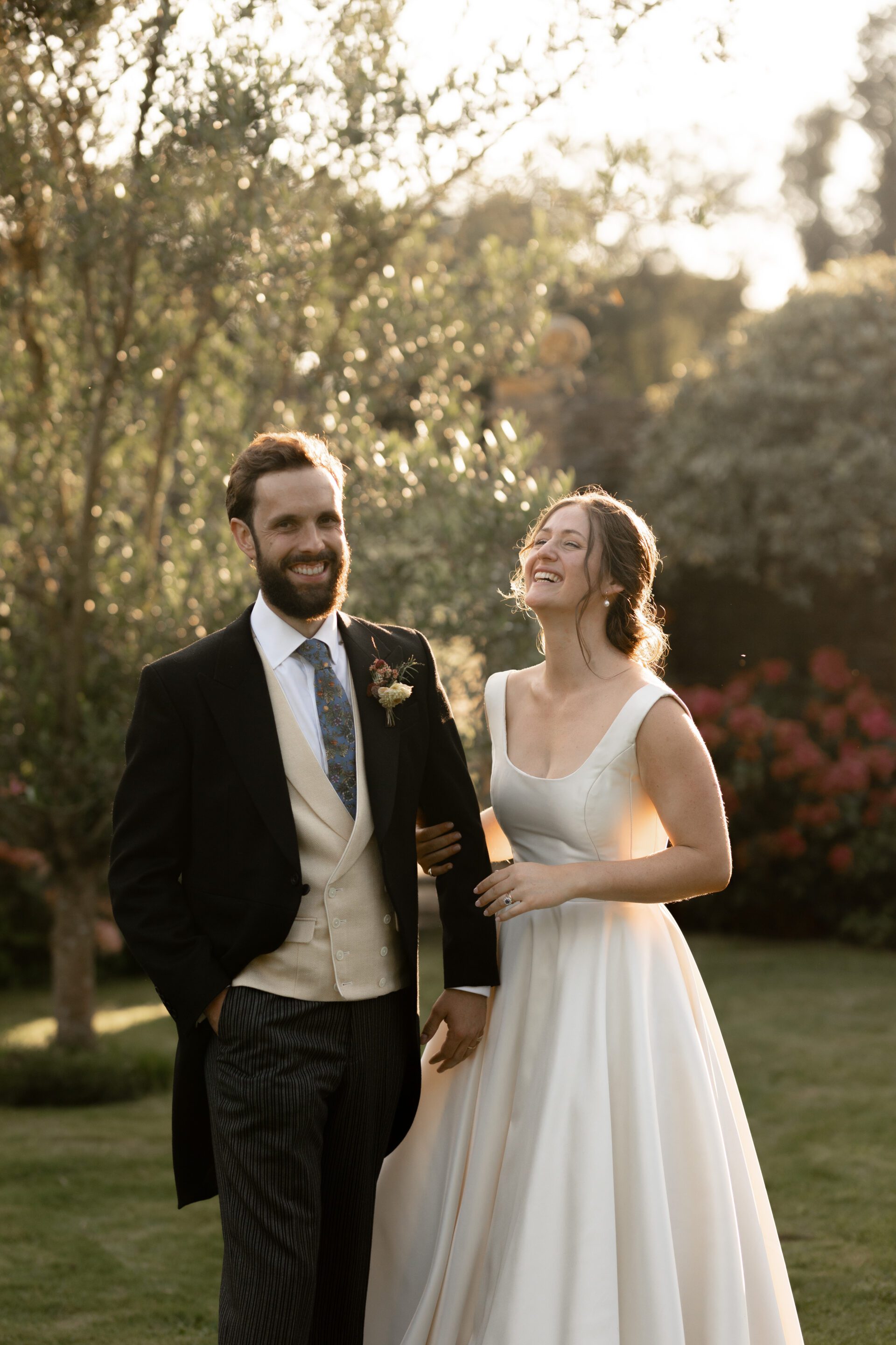 The bride and groom share a laugh during their golden hour couples session