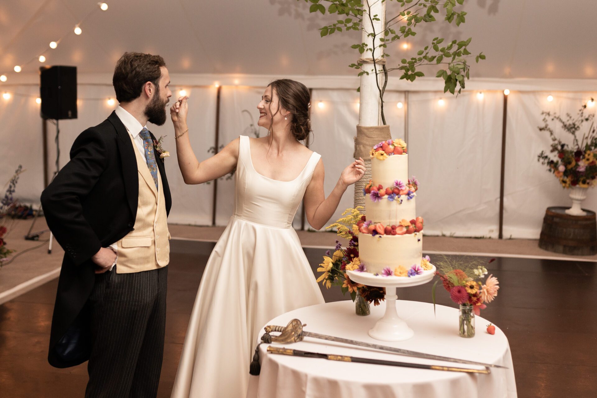 The bride and groom enjoy their wedding cake
