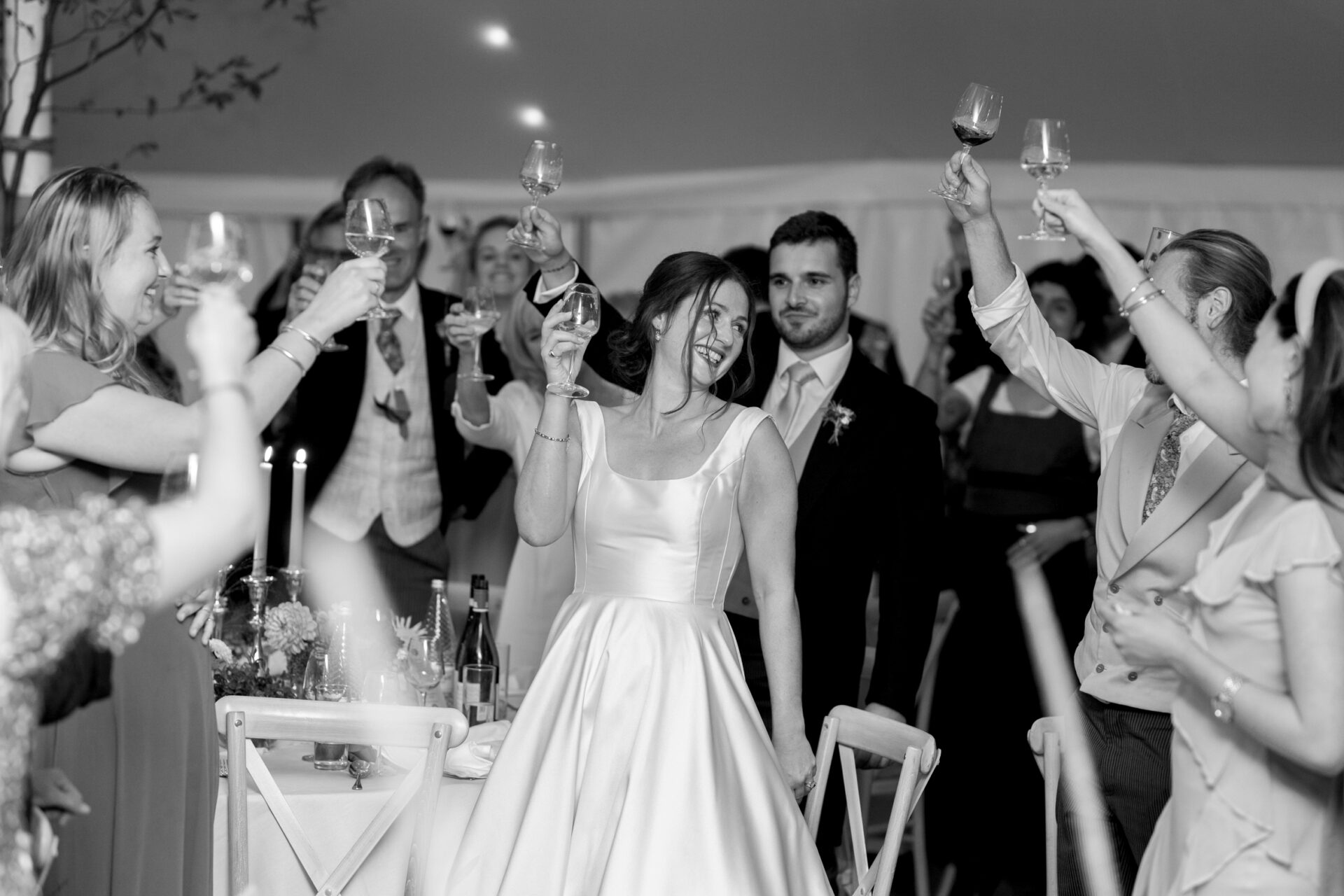 The wedding guests toast the bride during Somerset marquee wedding
