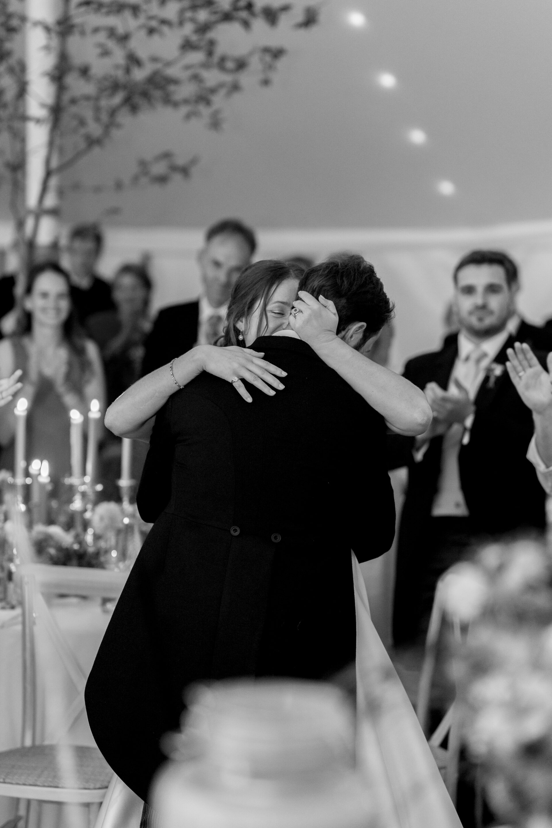 The bride and groom share an embrace during their Somerset marquee wedding