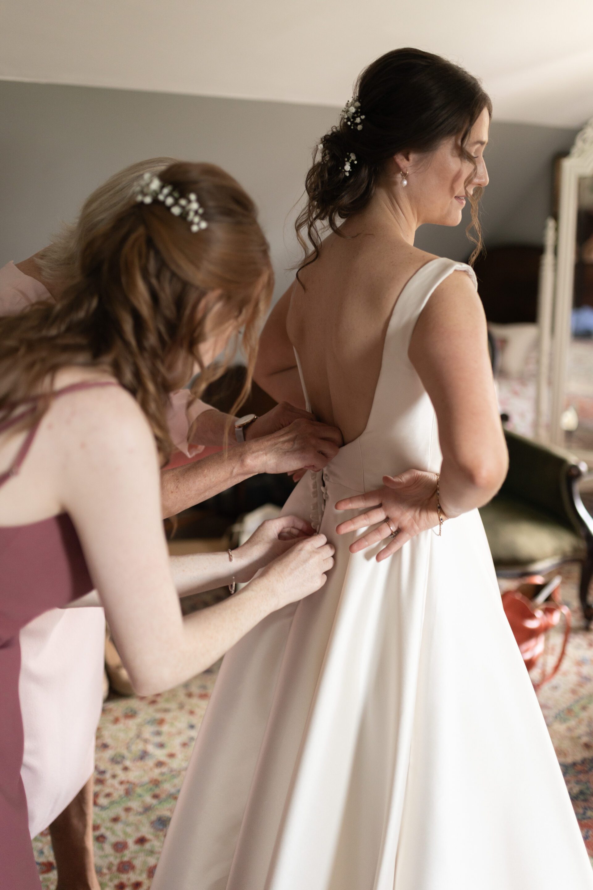 The bride gets into her Millie Couture wedding dress
