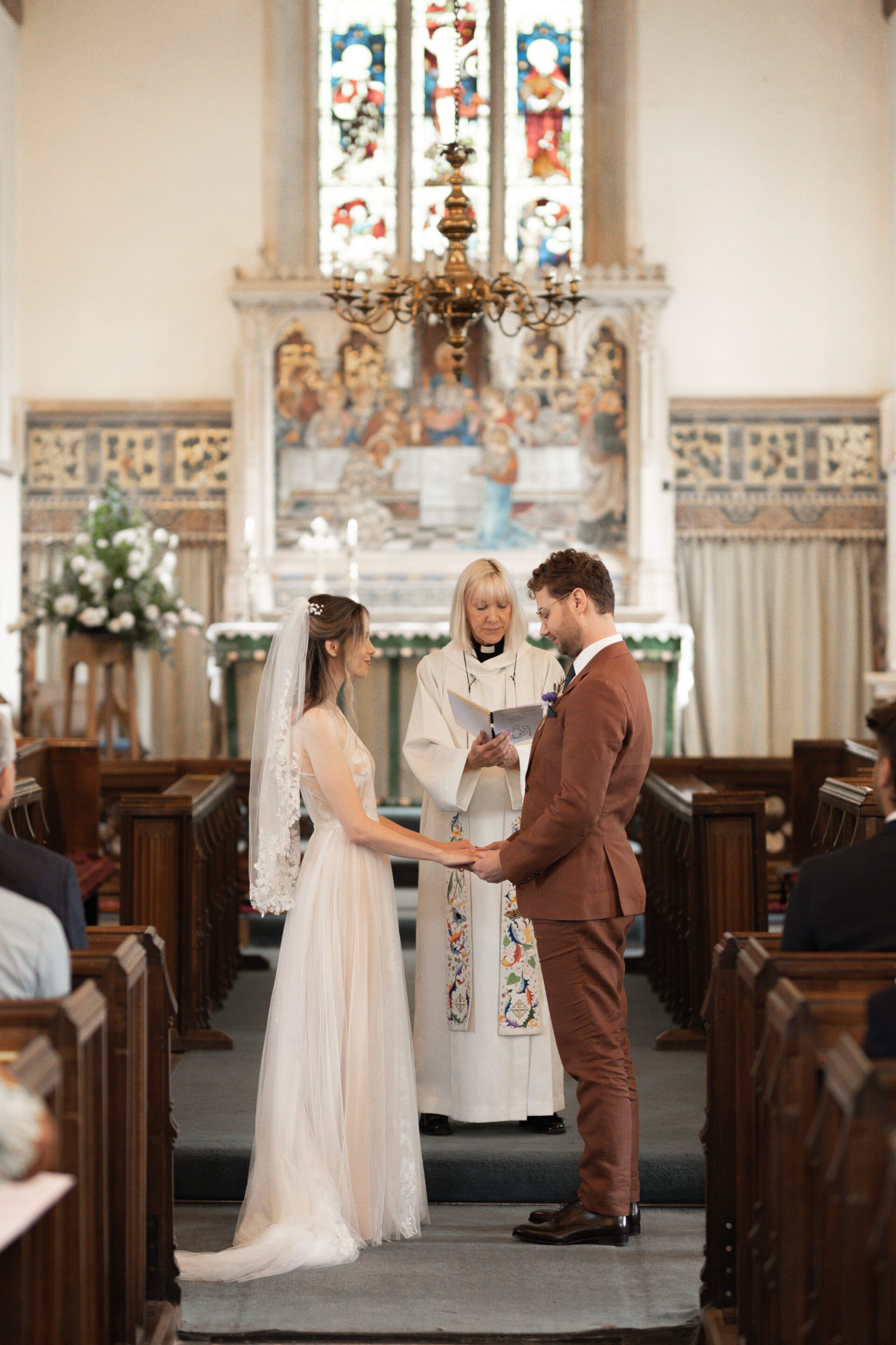 The bride and groom say their vows at their Gloucestershire church wedding