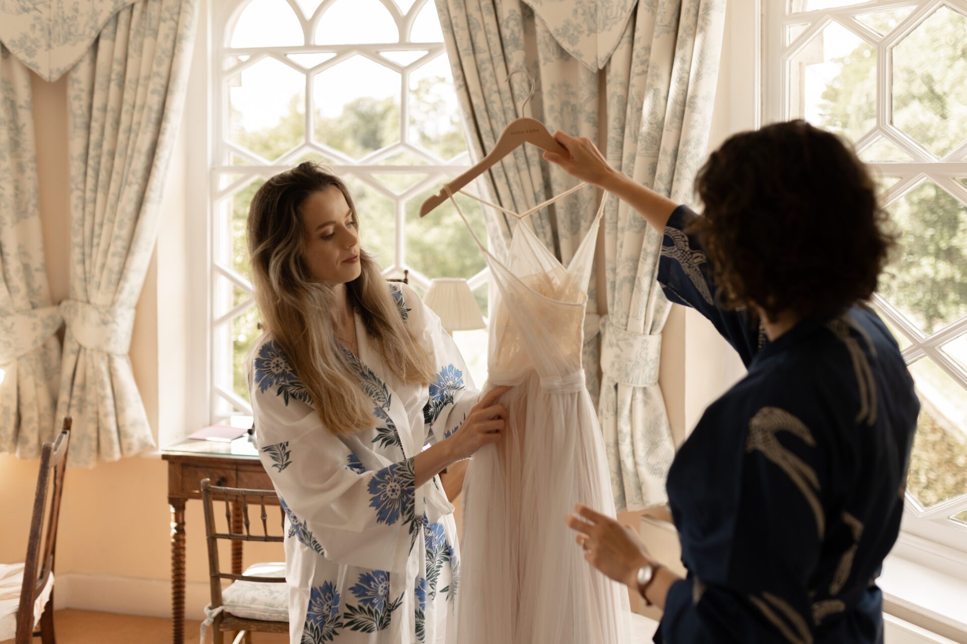 The bride gets ready to put on her wedding dress for her Gloucestershire wedding