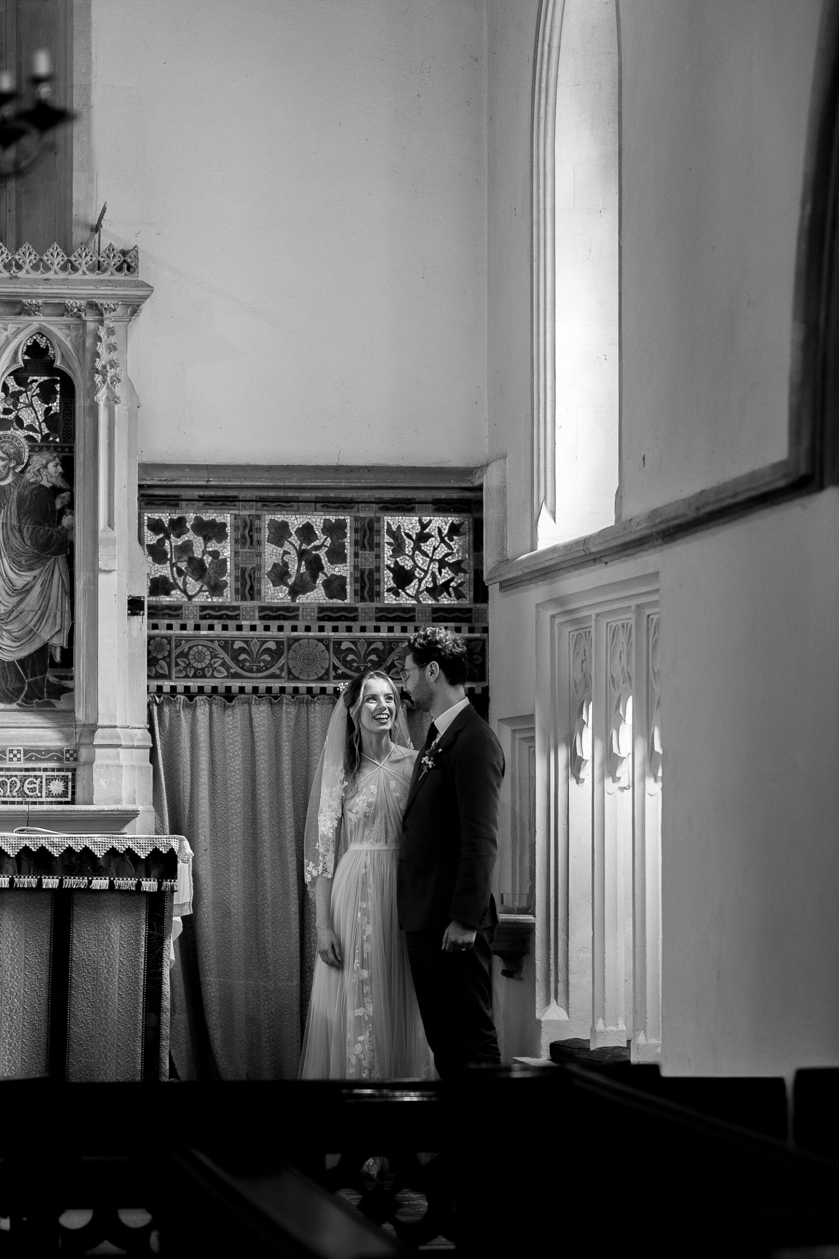 The bride and groom share a quiet moment during their church wedding in Gloucestershire