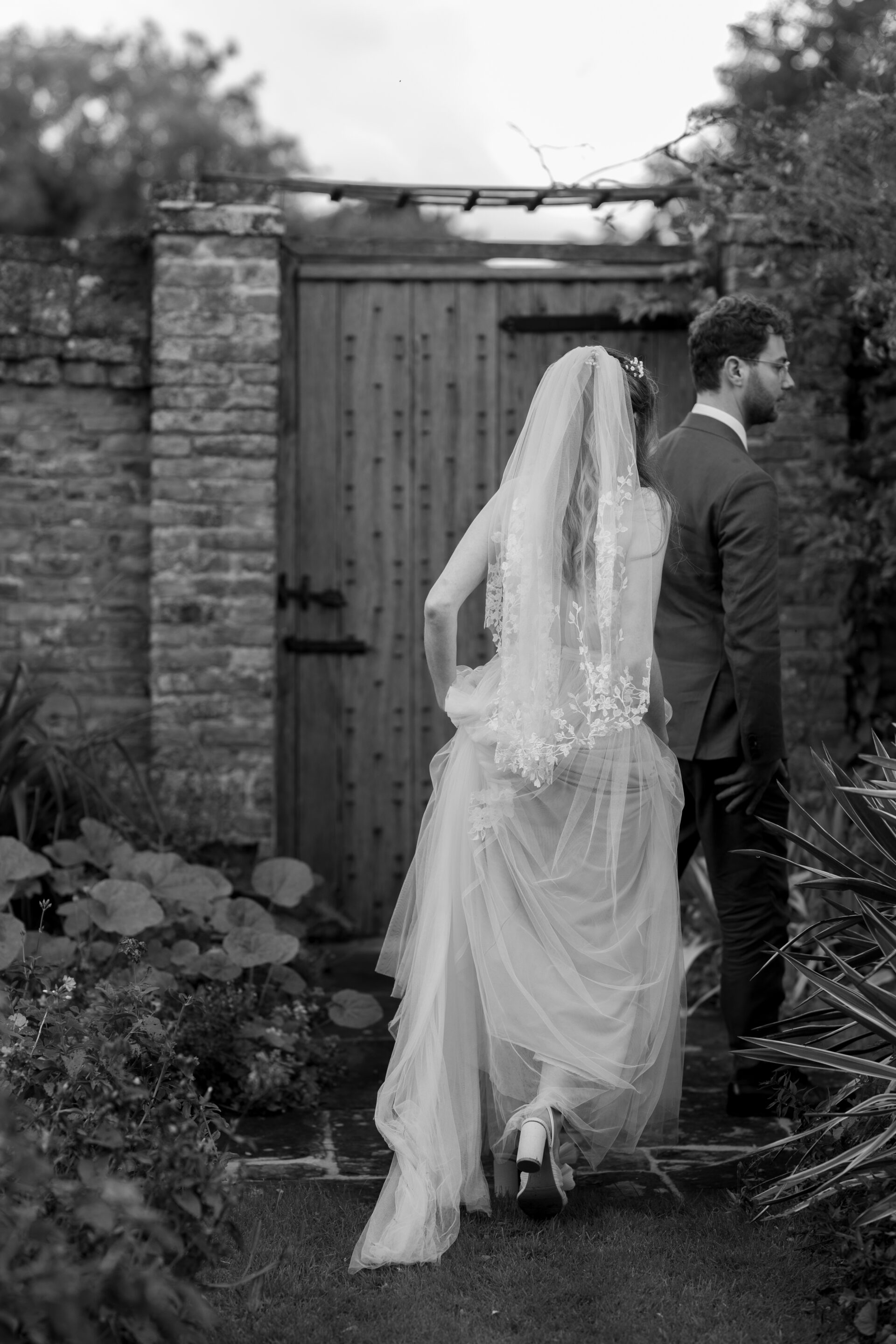 A candid portrait of the bride and groom at the Wool Barn, Gloucestershire wedding venue in Frampton