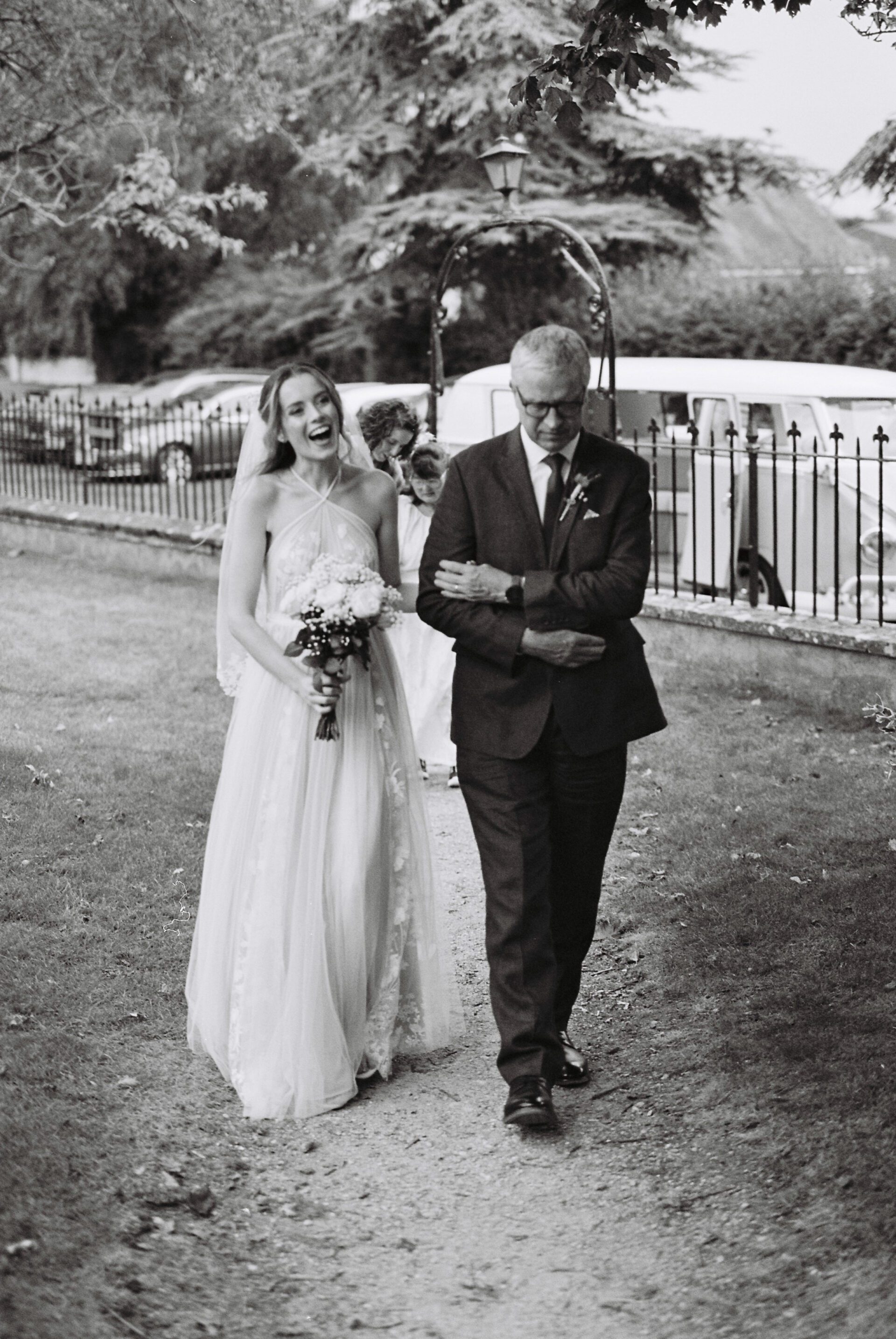 The bride arrives at the church with her father, captured on 35mm film
