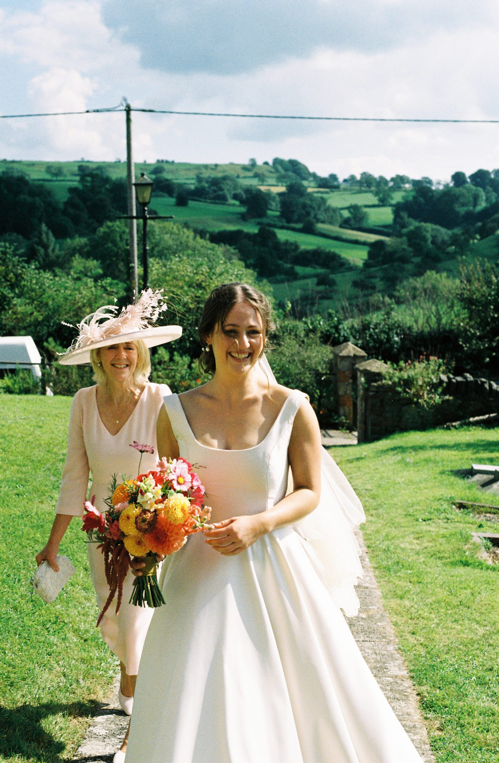The bride arrives at the church with her mother captured on 35mm