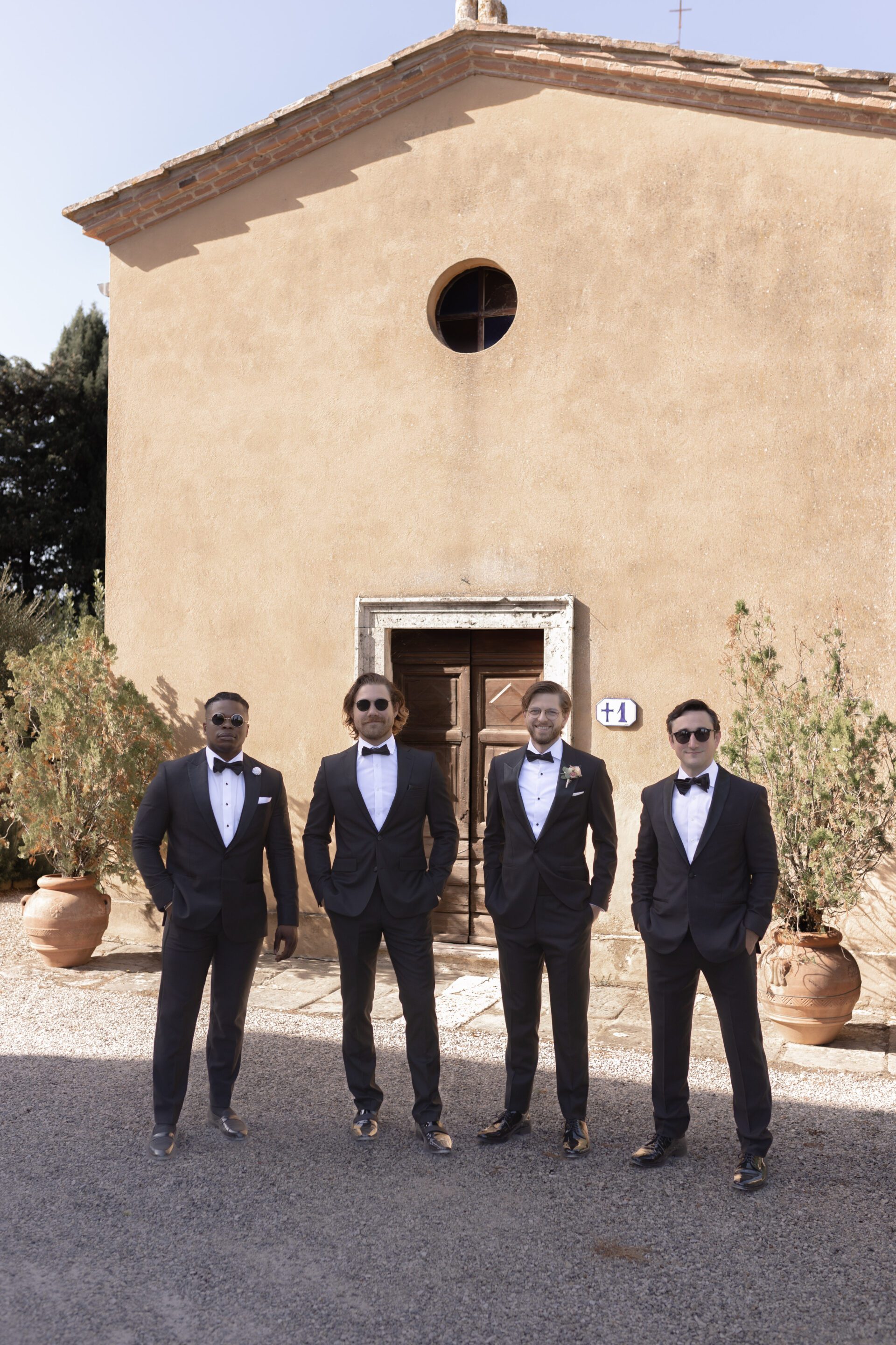 Portrait of the groom with his groomsmen at Casa Bianca, Italian wedding venue